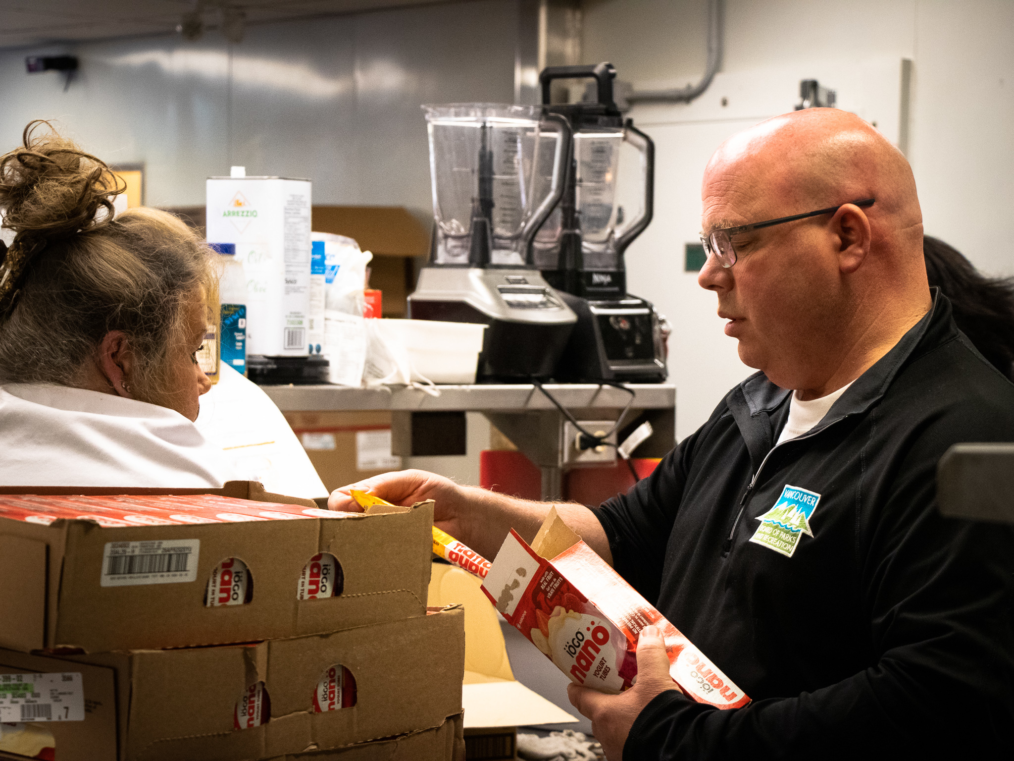 Mark Halyk (right) is in charge of the hamper program. His job includes sourcing nutritious, low-cost food. 