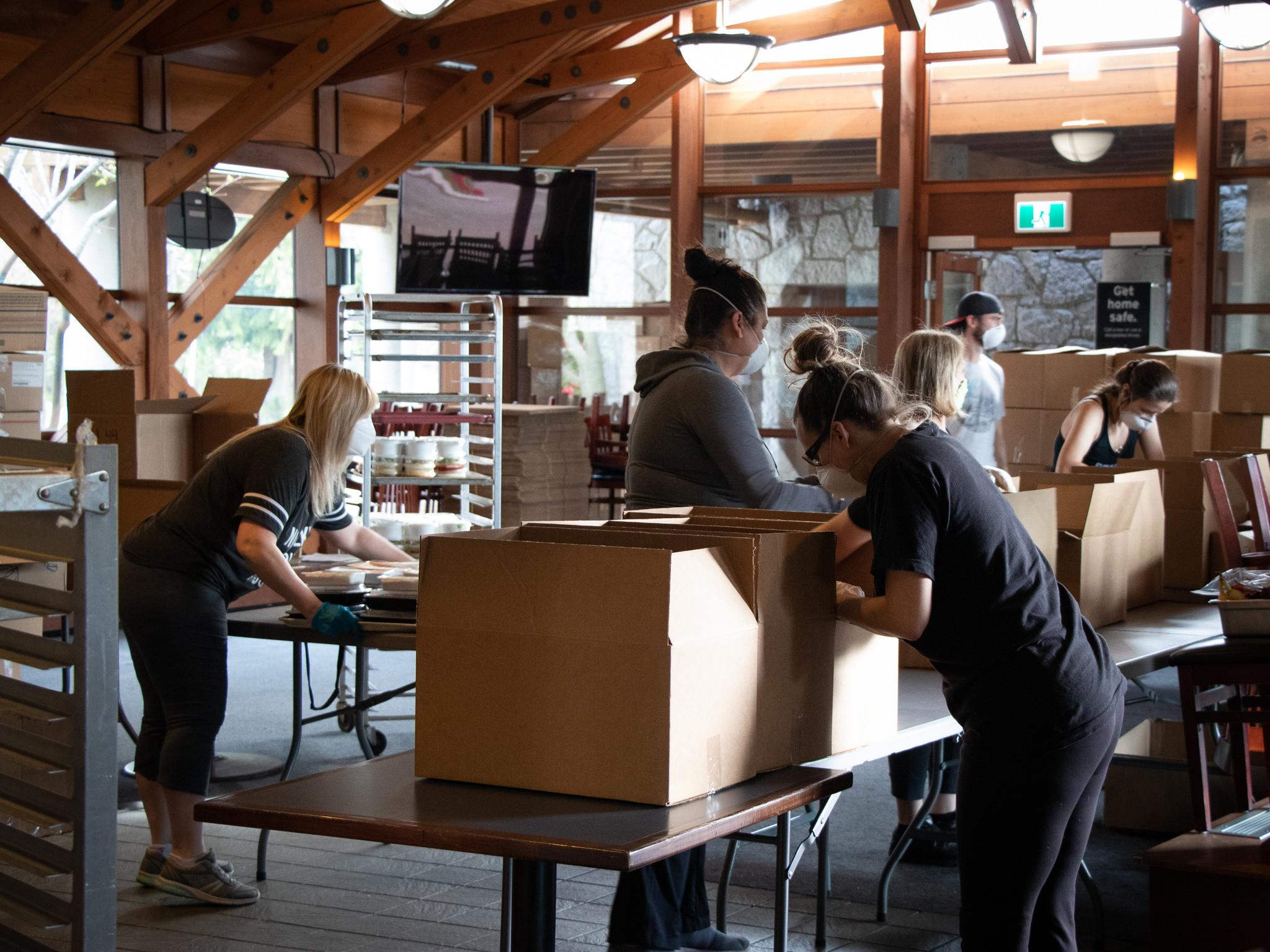 Staff form an assembly line to prepare more than 100 hampers in just over an hour at the Langara Golf Course clubhouse.