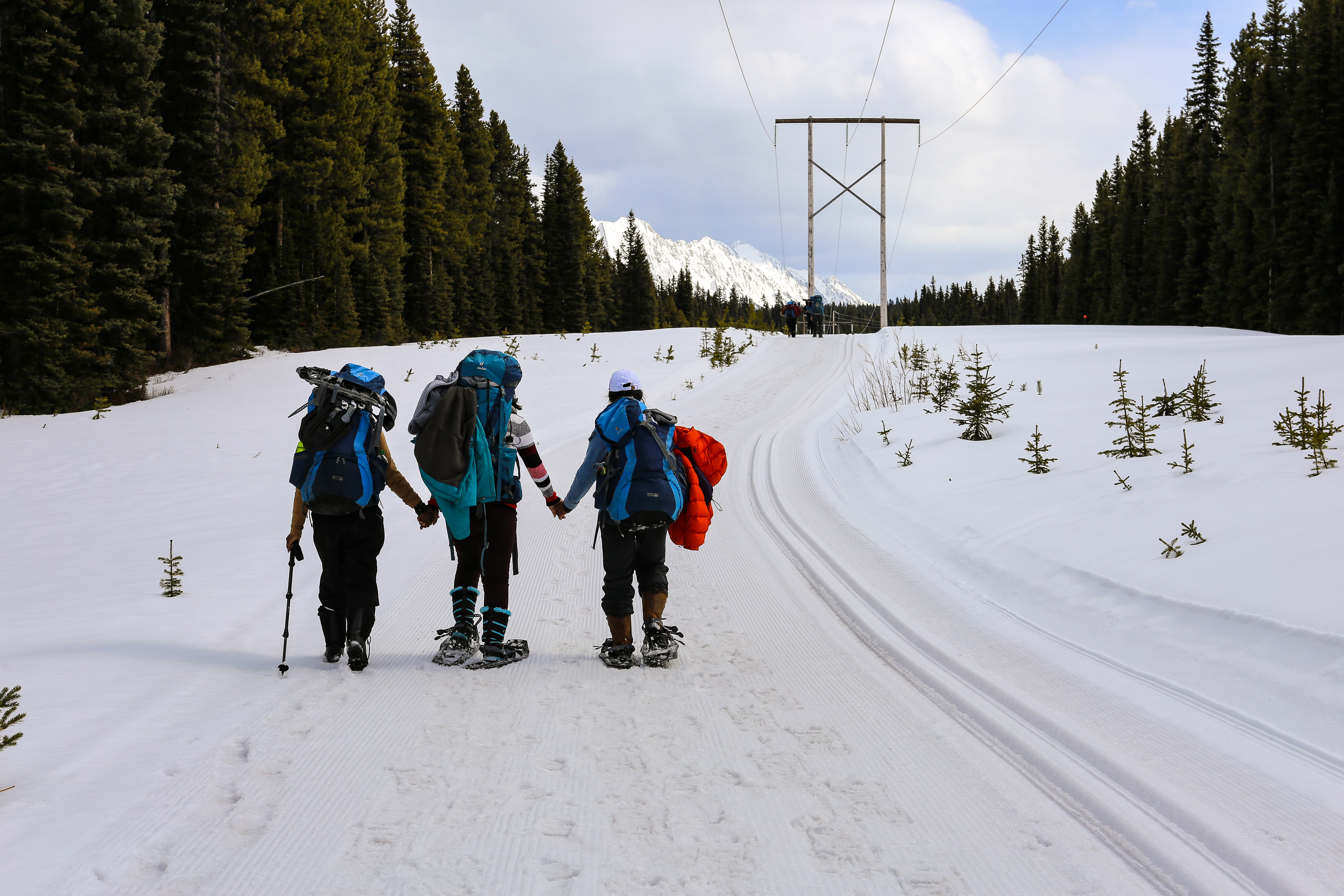 A few of the women walk hand in hand on the trail to give each other energy and strength. (Emily Rendell-Watson/CBC)
