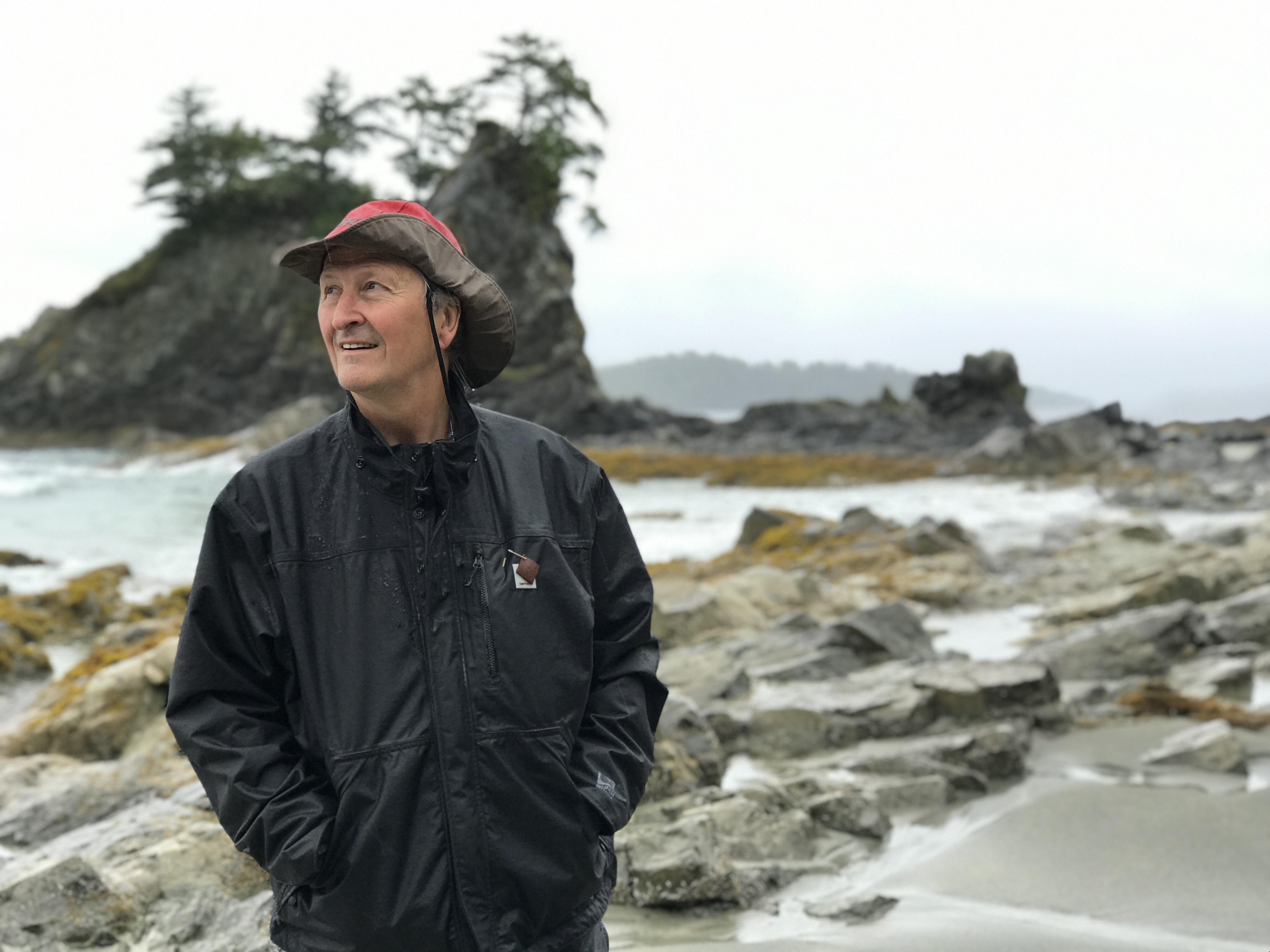 Keith Wyton, a Bamfield resident since 1979, watches an eagle fly away at Brady's Beach. (Megan Thomas/CBC)