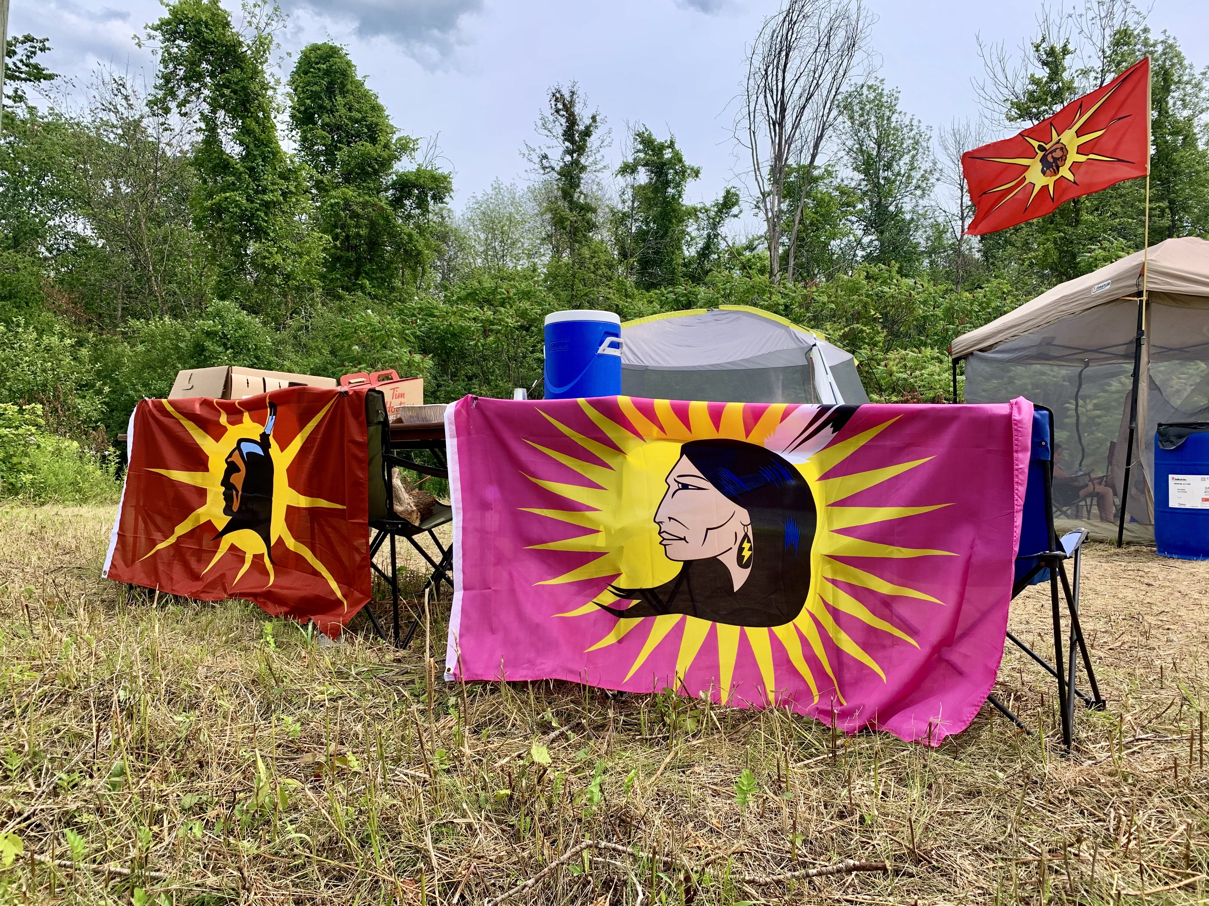 The main camp is located on Parcel E, an area of land that was returned to Kahnawake in 2018, while smaller camps are scattered across the adjacent property that is being reclaimed to prevent a housing development project. (Ka’nhehsí:io Deer/CBC)  