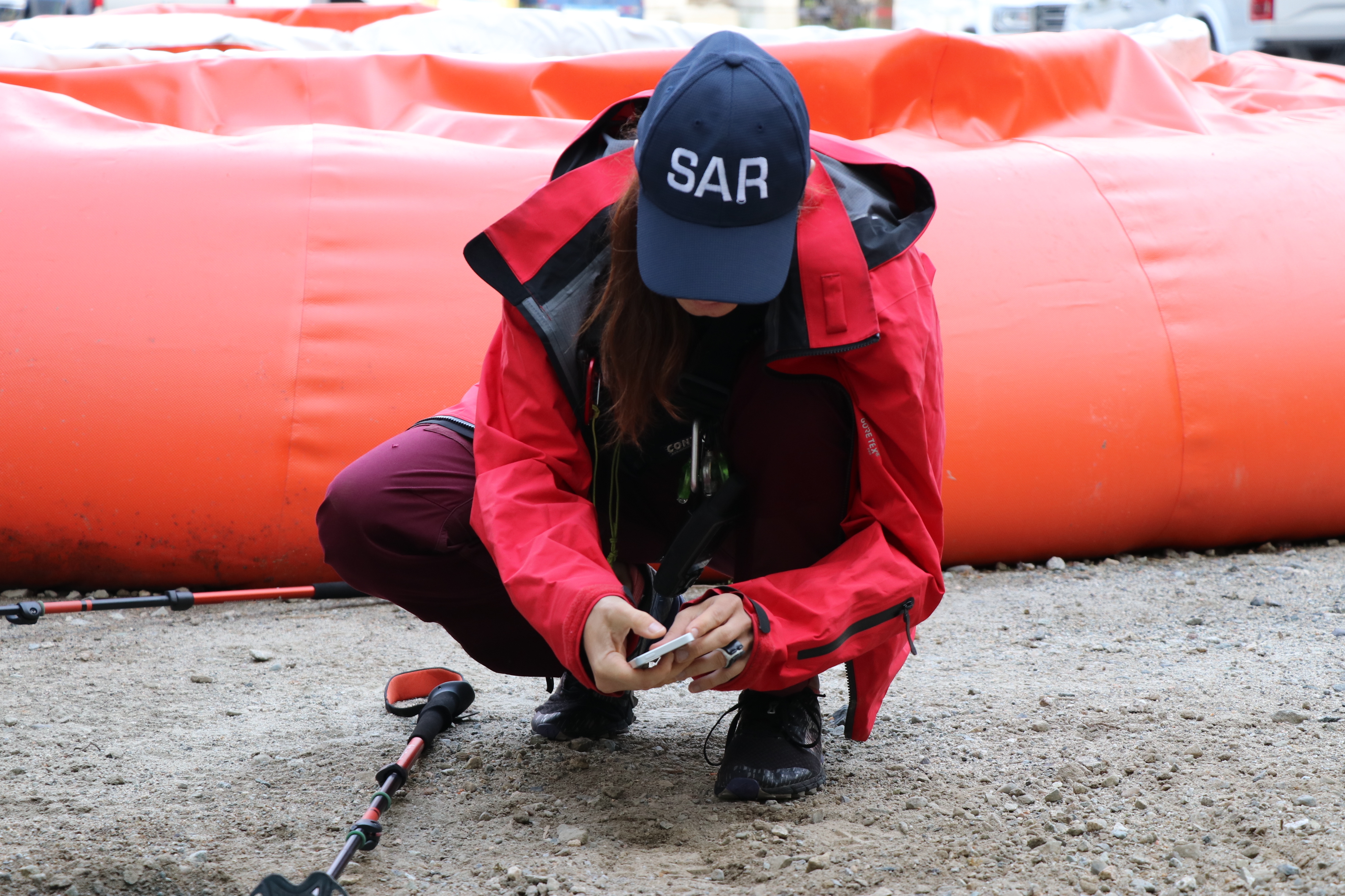 Maria Masiar captures a photo of the footprint with her phone as part of the training exercise. (Clare Hennig/CBC)