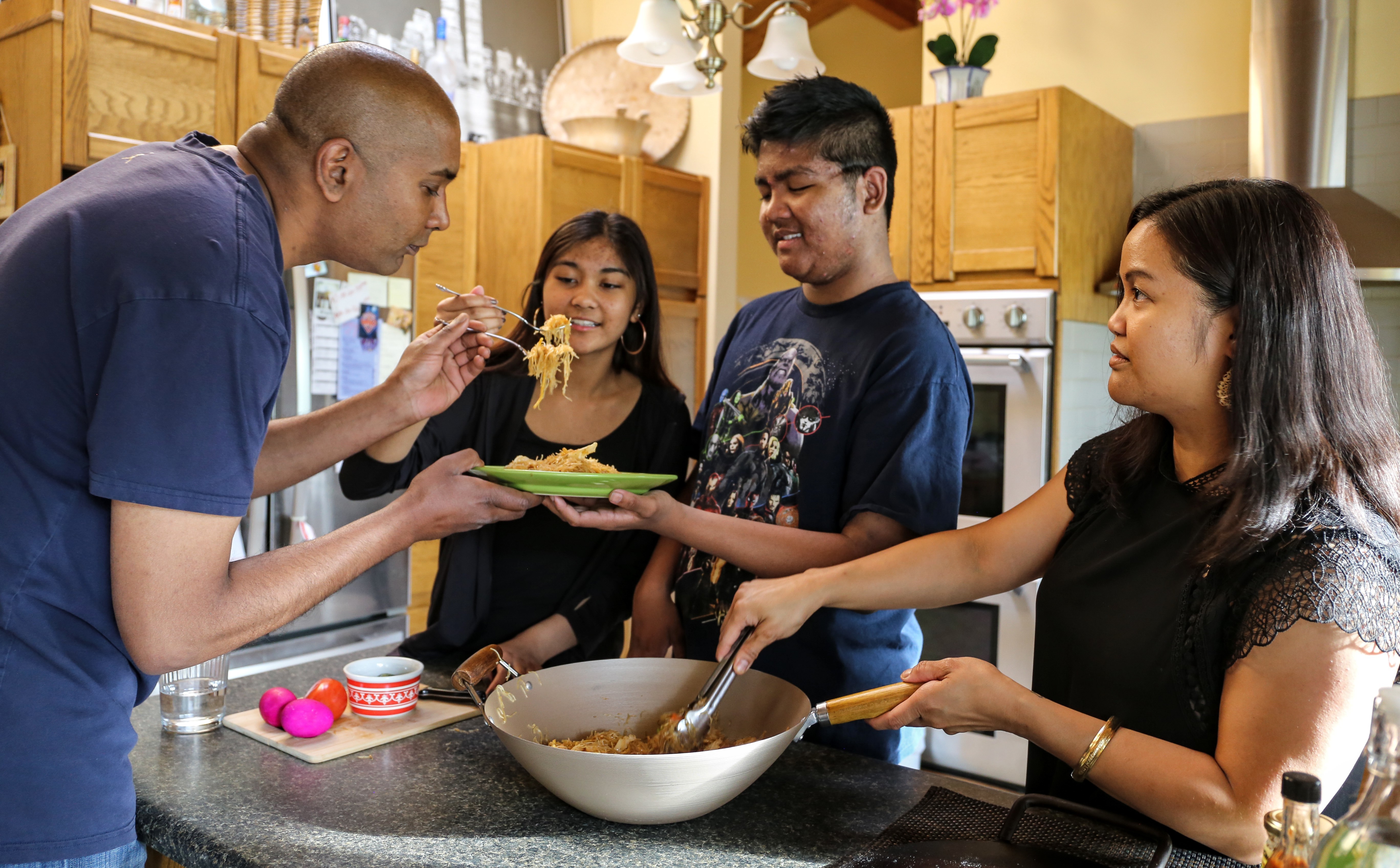 Jeanette Dotimas and her family, son, Atlas, daughter, Isabelle, and husband, Arif Moffett, gather for a meal. (Emily Rendell-Watson)