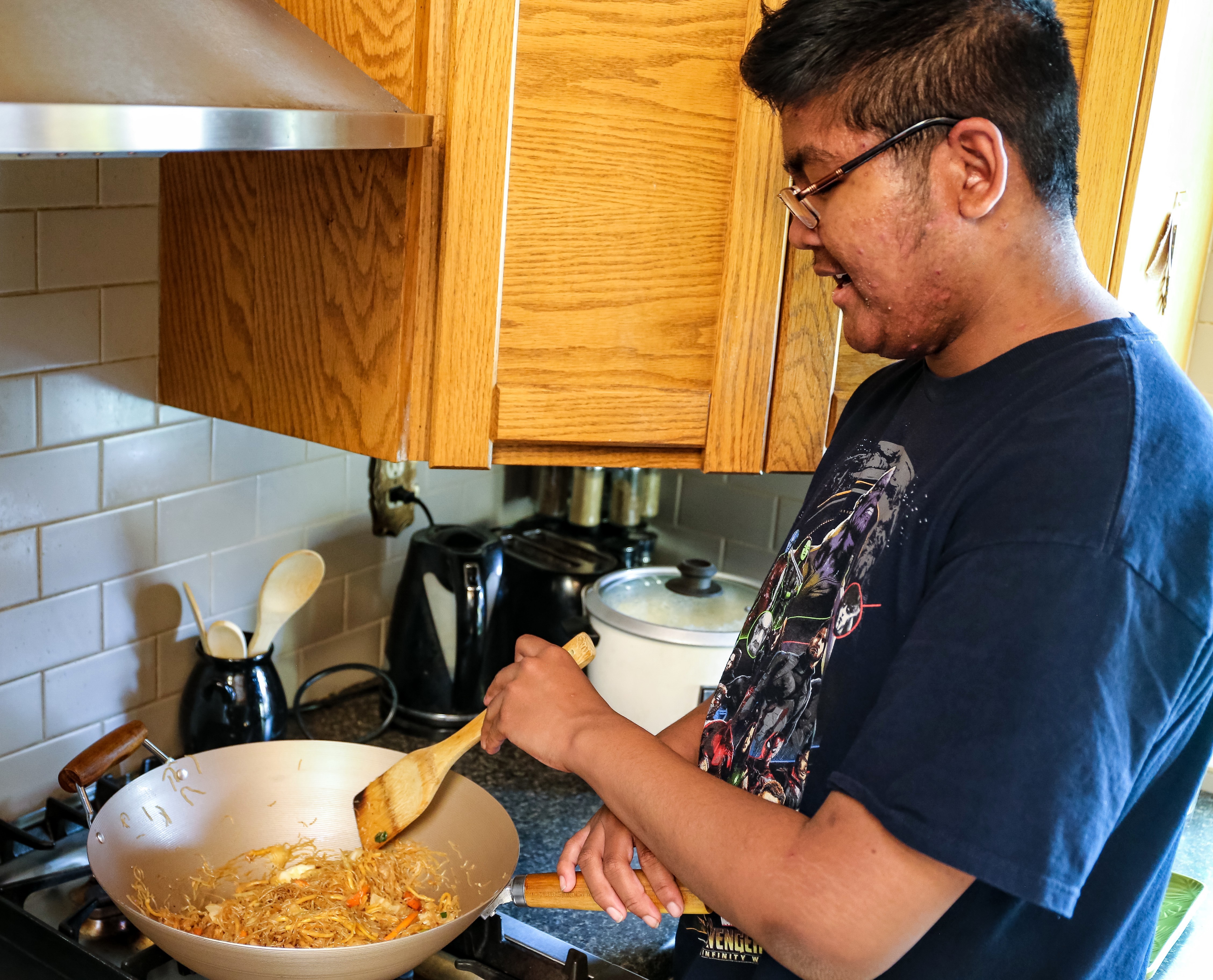 Atlas Moffett helps make up a dish of pansit. (Emily Rendell-Watson)