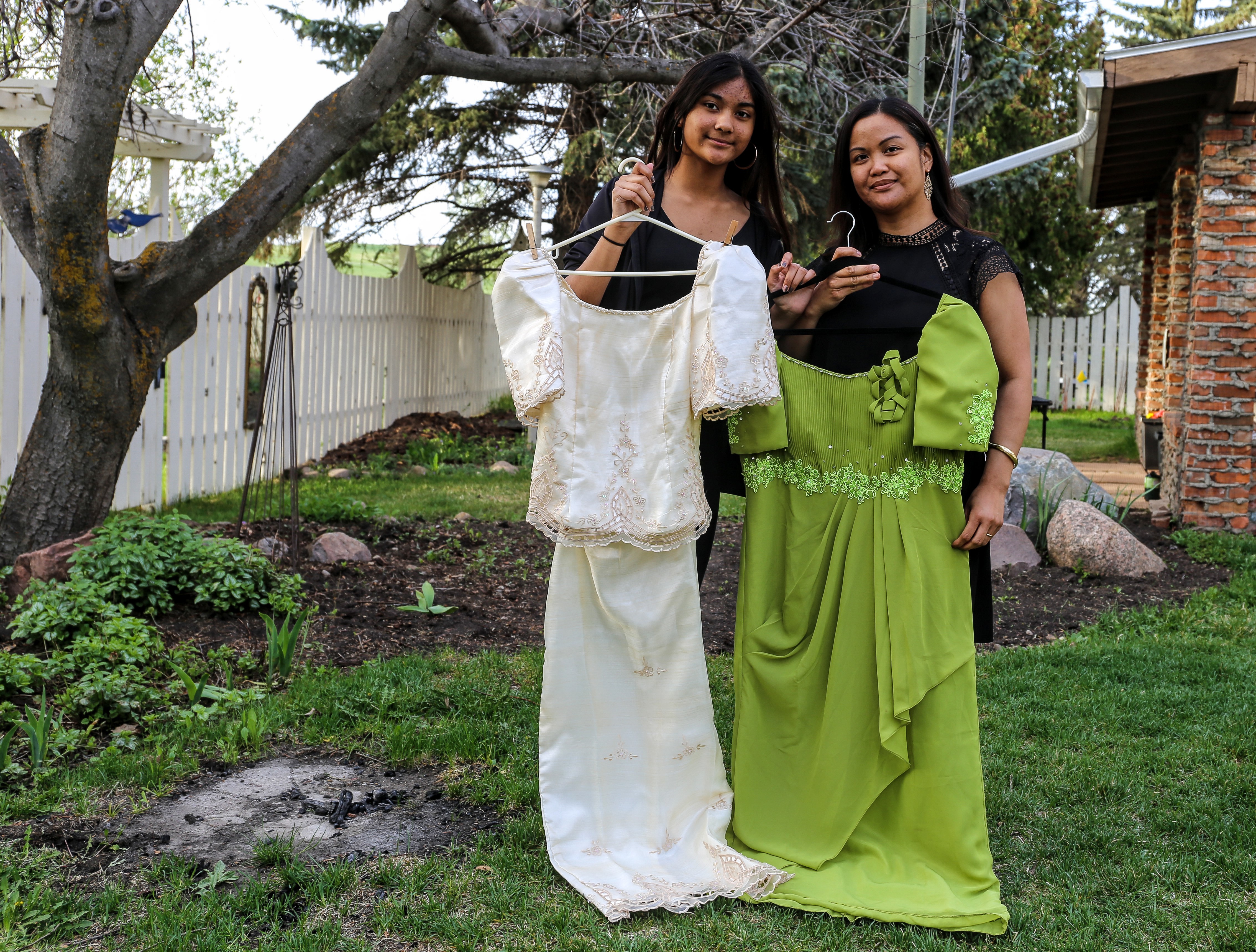 Dotimas and her daughter, Isabelle, show their traditional dresses, known as Filipiniana terno.