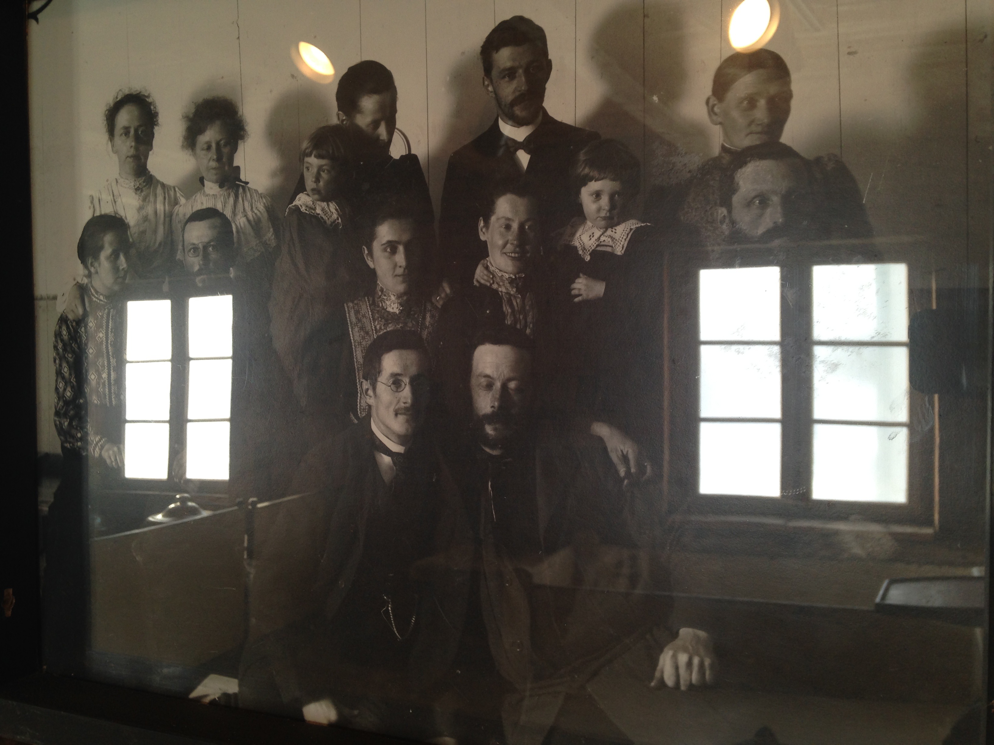 The windows of the mission building are reflected in the faces of missionaries. (Angela Antle/CBC)