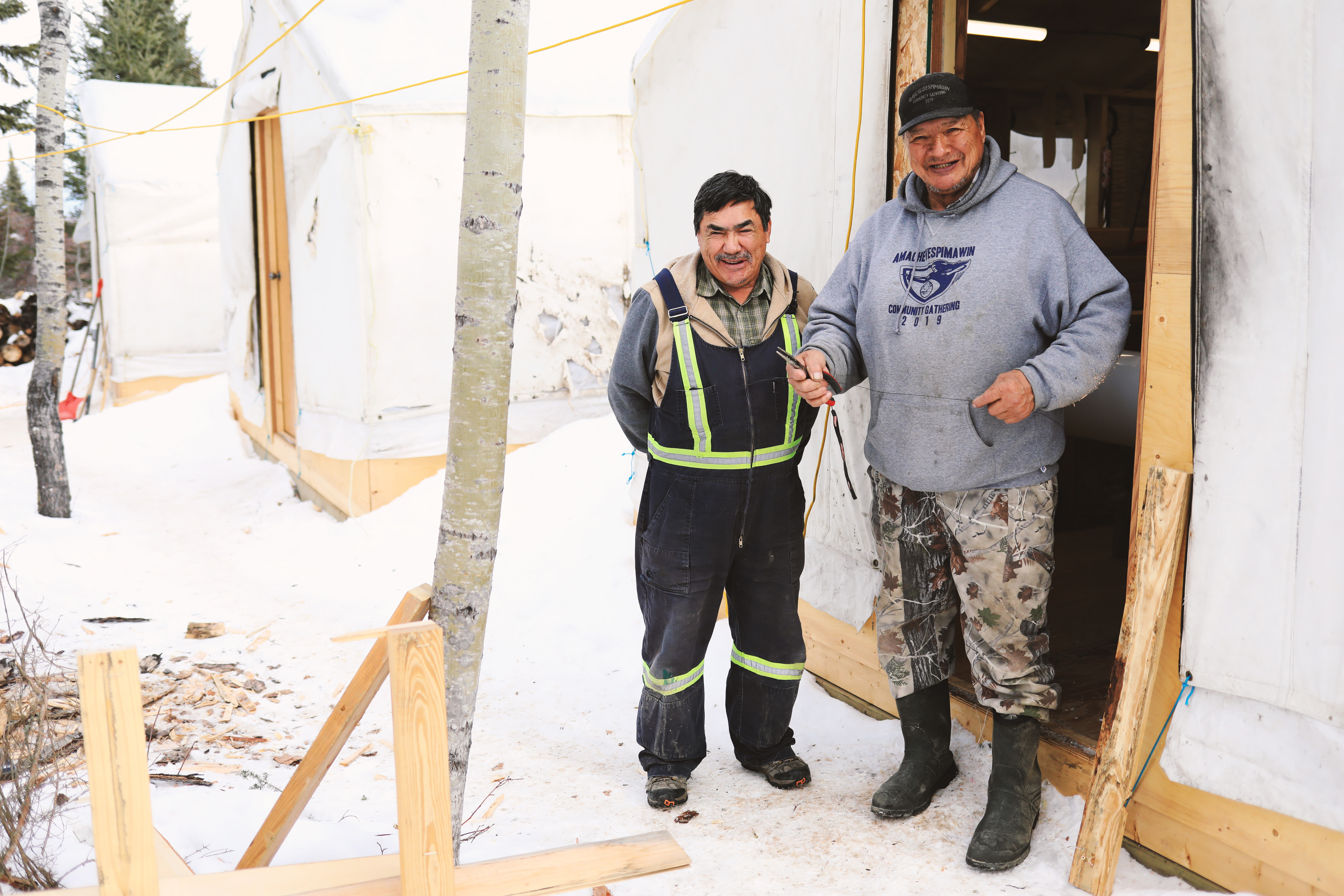 Elders Peter Roberts and Isaiah Roberts work out at the land-based site to teach the students traditional skills. (Heidi Atter/CBC)