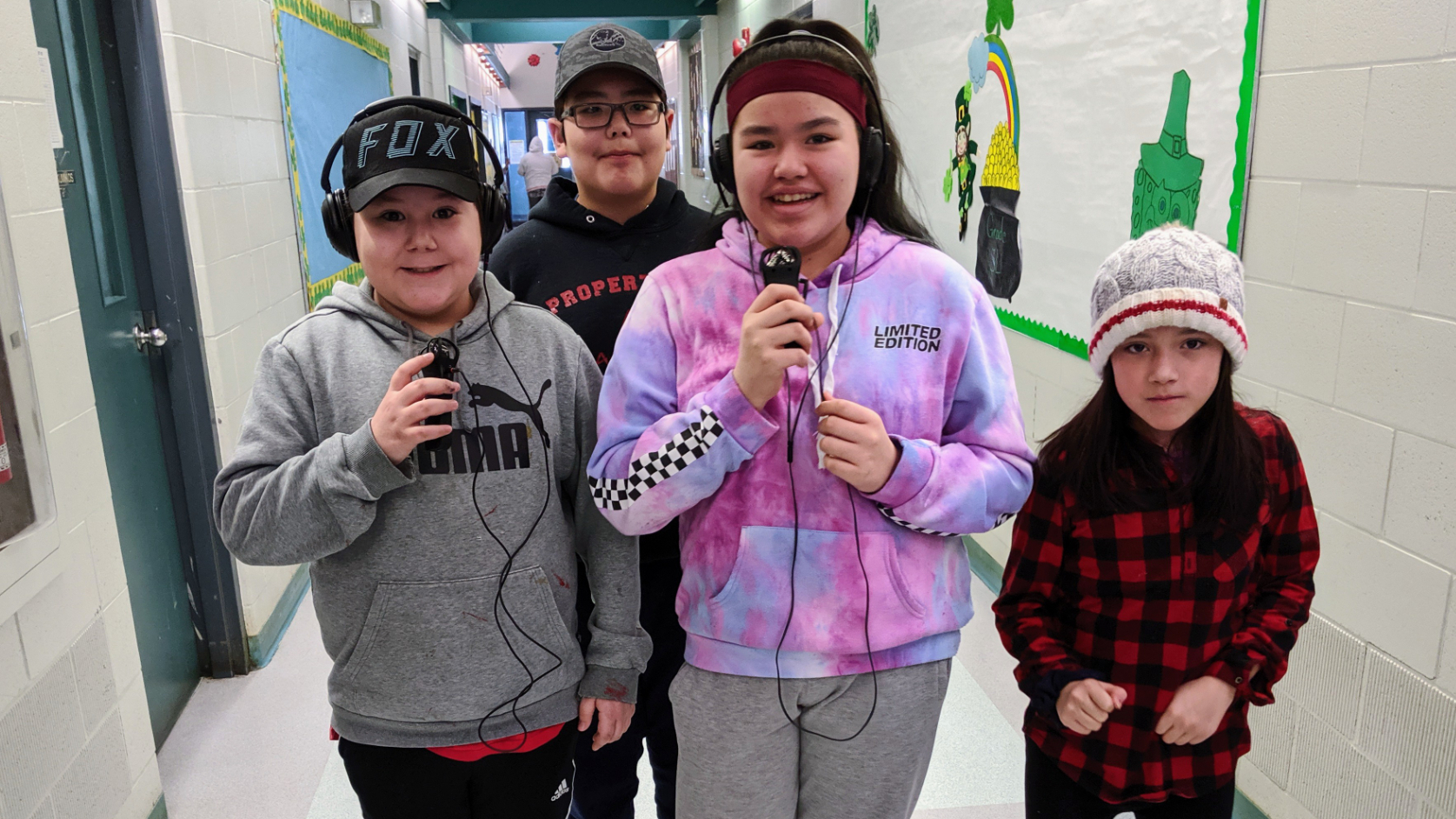 Elementary students walk around the halls recording each other and others after an audio workshop hosted by the CBC's Heidi Atter. (Heidi Atter/CBC)