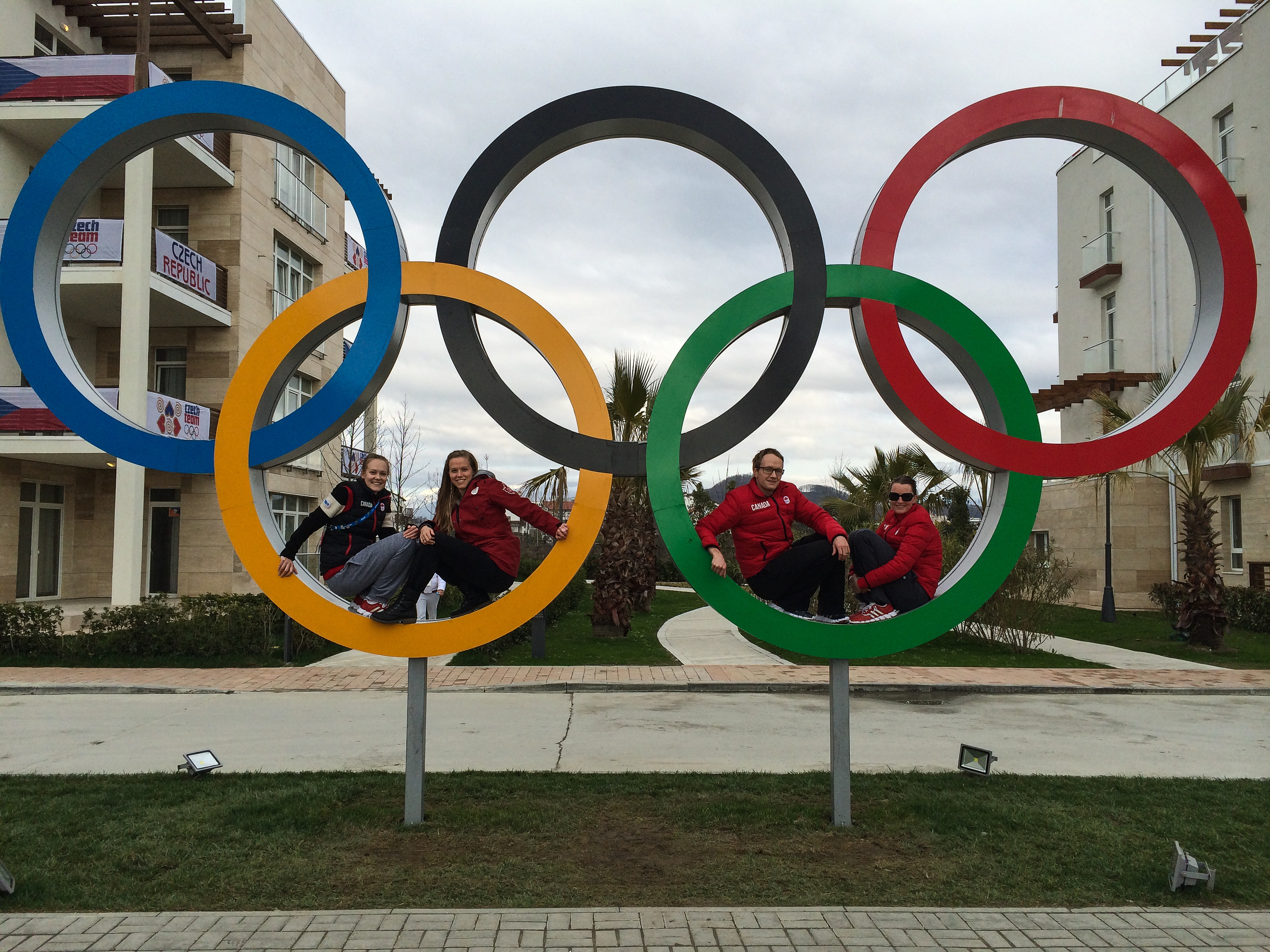 Siblings Jessica Levins, Sarah O'Neill and Jamie Gregg, along with Jamie's wife, Danielle, pose for a photo with the rings in the Sochi athletes village. (Supplied by Kathy Gregg)