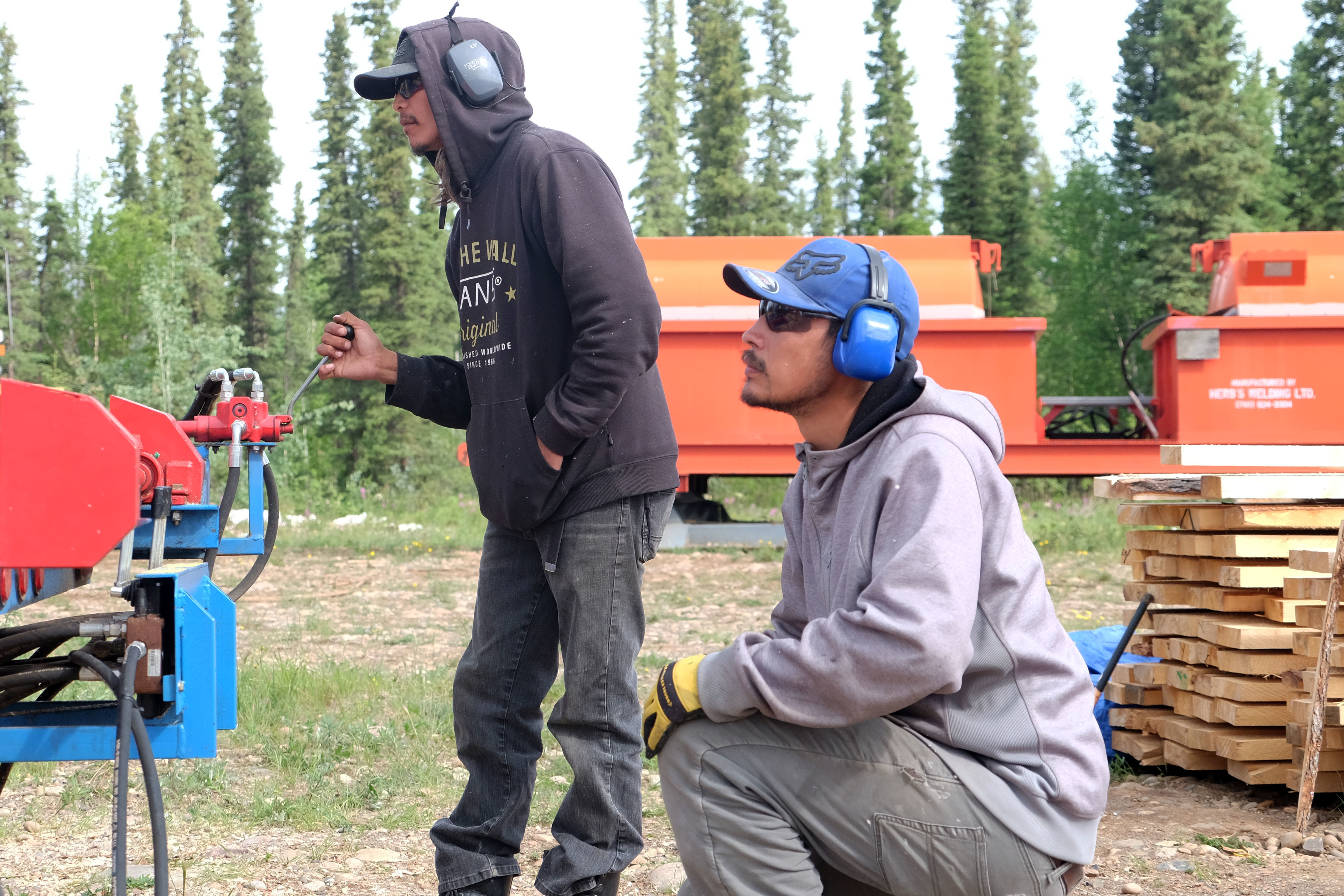 Joseph Tobac, left, and Joel Lafferty work on the sawmill in Fort Good Hope as the massive spruce log begins turning into boards. 