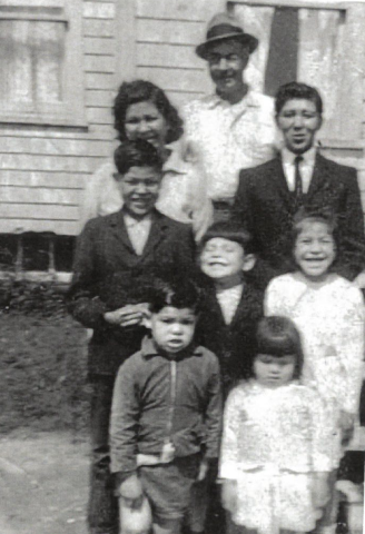 Judy Clark shown as a young girl, smiling at middle right, with her family on Lennox Island. (Submitted by Judy Clark)