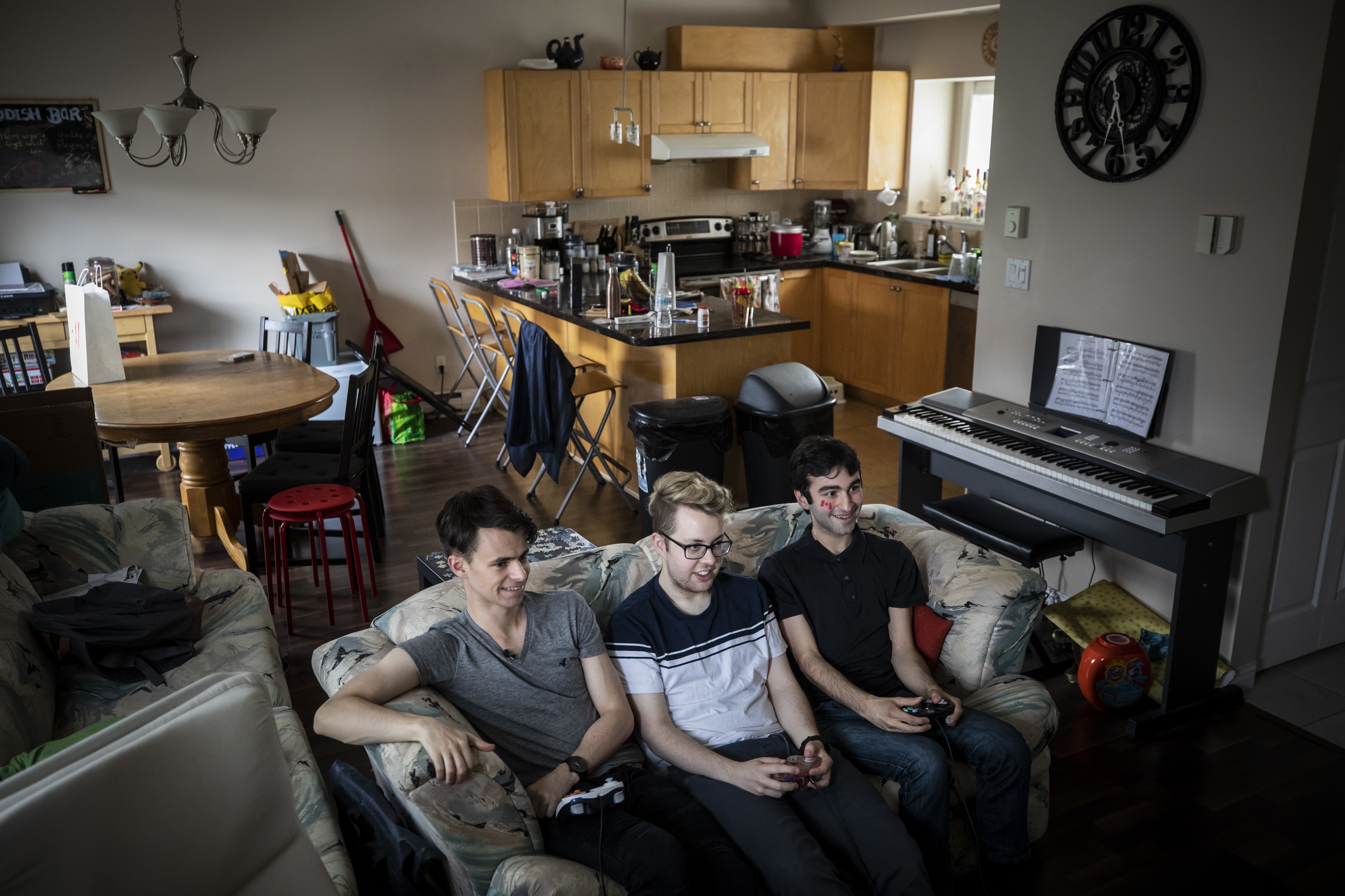 Landon Trybuch, left, shares a Burnaby townhouse with three other pro smash Bros. players. At centre is his roommate Mason "Locus" Charleton, 21, and at right is their friend, Leonard "Len" Zaein, 21. All three have big hopes for Pinnacle 2019. (Ben Nelms/CBC)