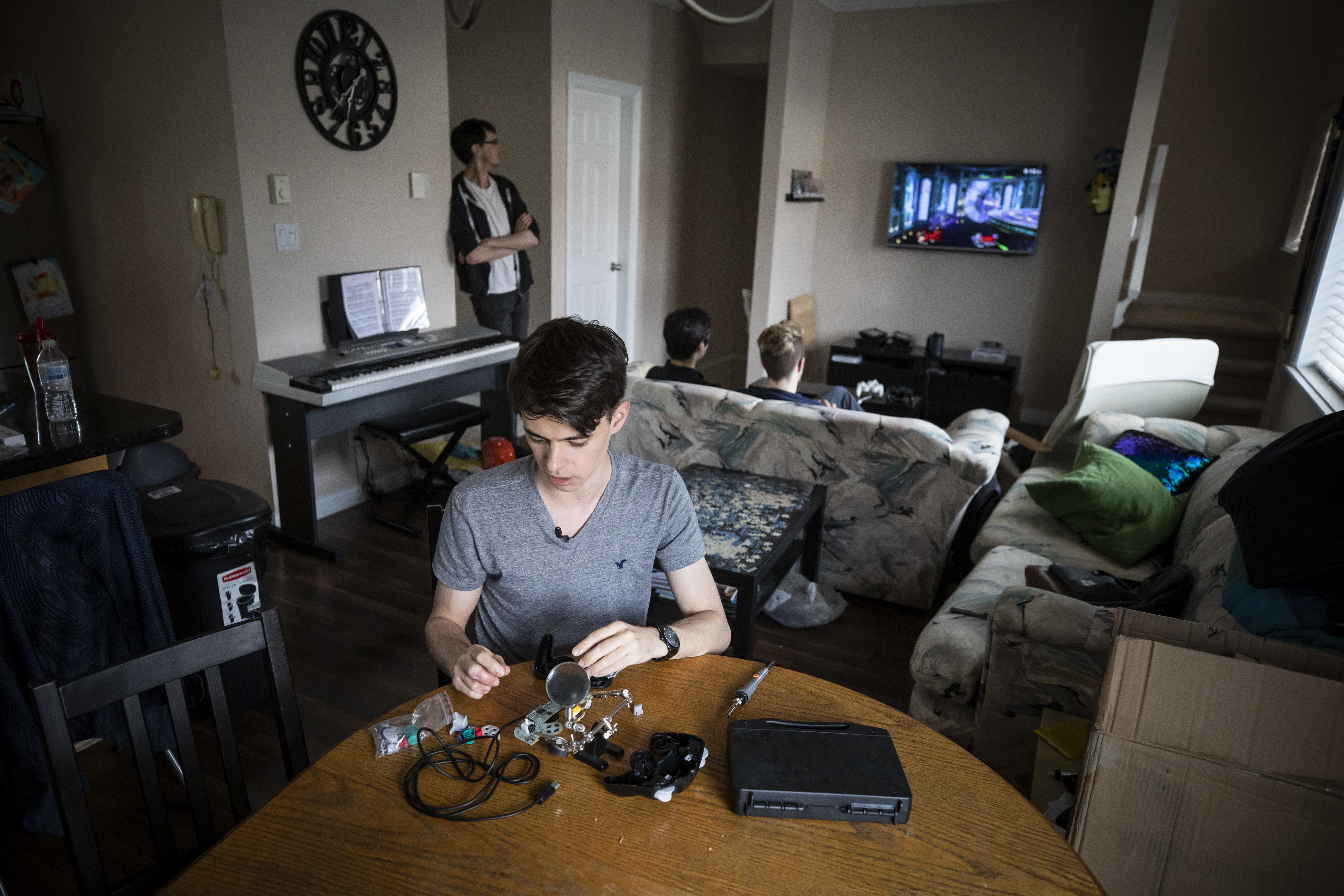 Landon Trybuch says there's a common, frustrating misconception that esports athletes are lazy and are avoiding real jobs. He's showing off his soldering equipment. Like many pro players, he builds and modifies his own custom controller to fit his playing style. (Ben Nelms/CBC)