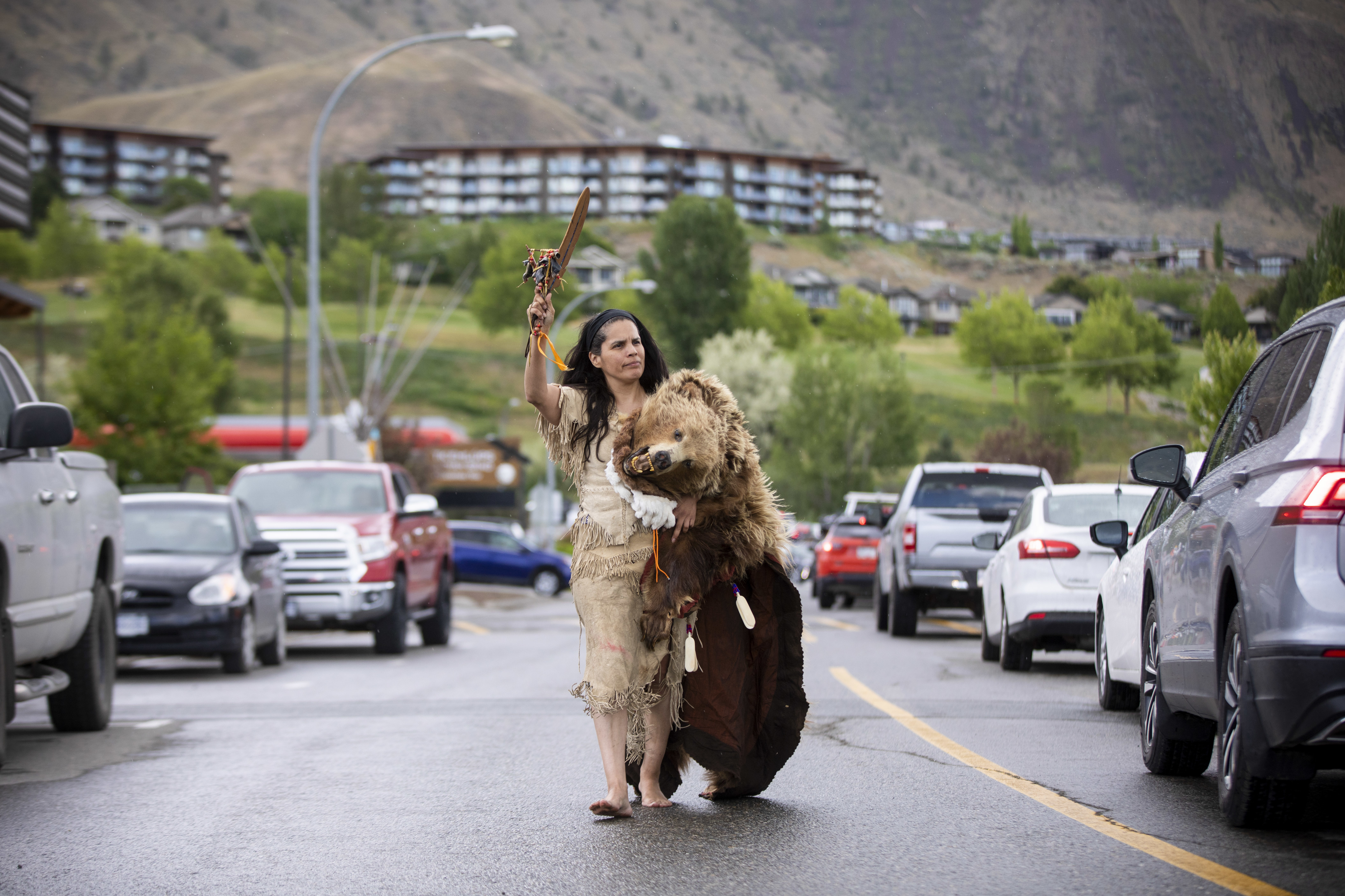 Macaoz’alus (Jackie Andrew) of the Lil'wat First Nation walks down the road on her way to the former Kamloops Indian Residential School to pay her respects.