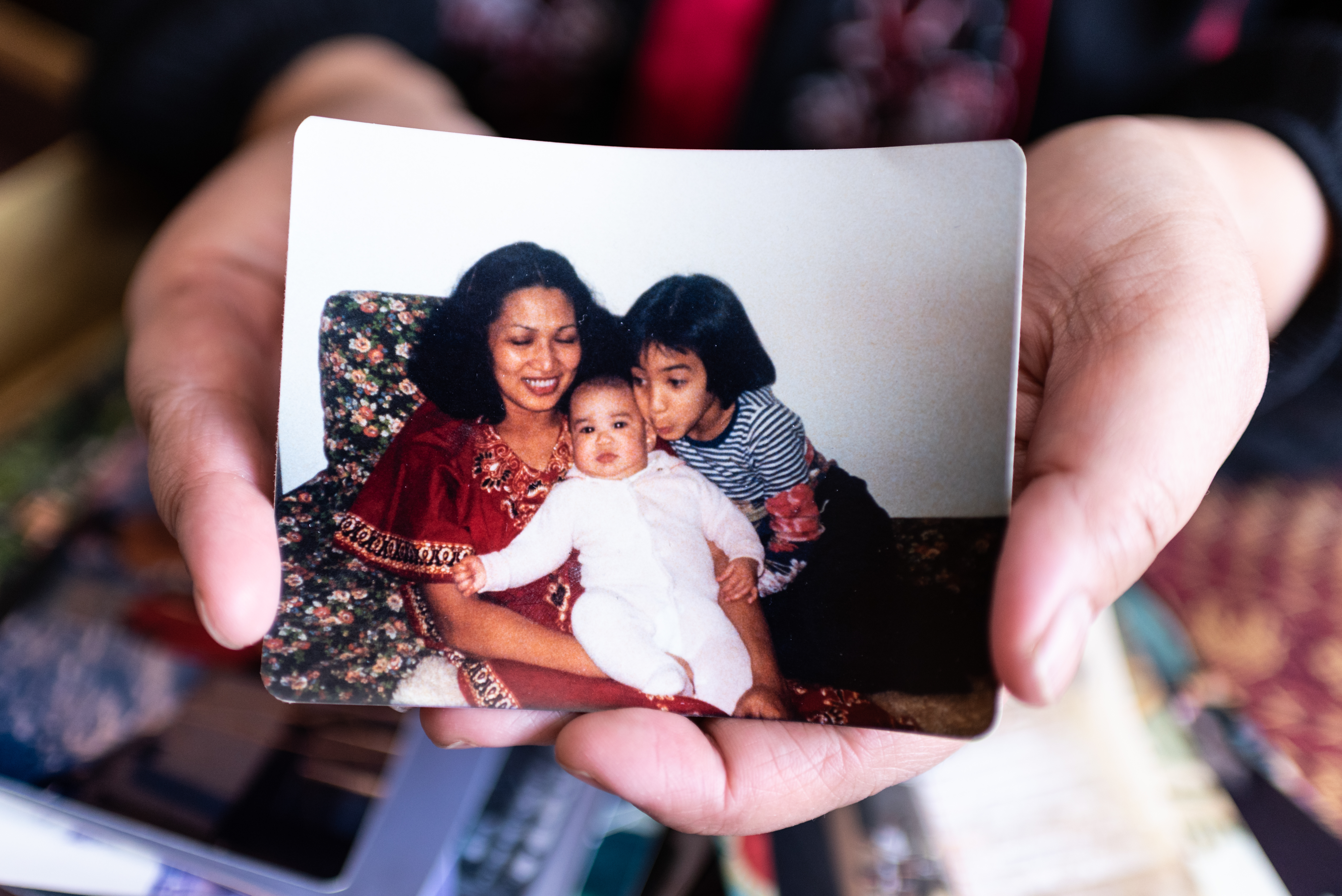 Kris Alvarez holds a picture of herself as an eight-year-old with her mother, Susan, and her brother Joe. The family moved to Regina in 1974 (Michael Bell). 