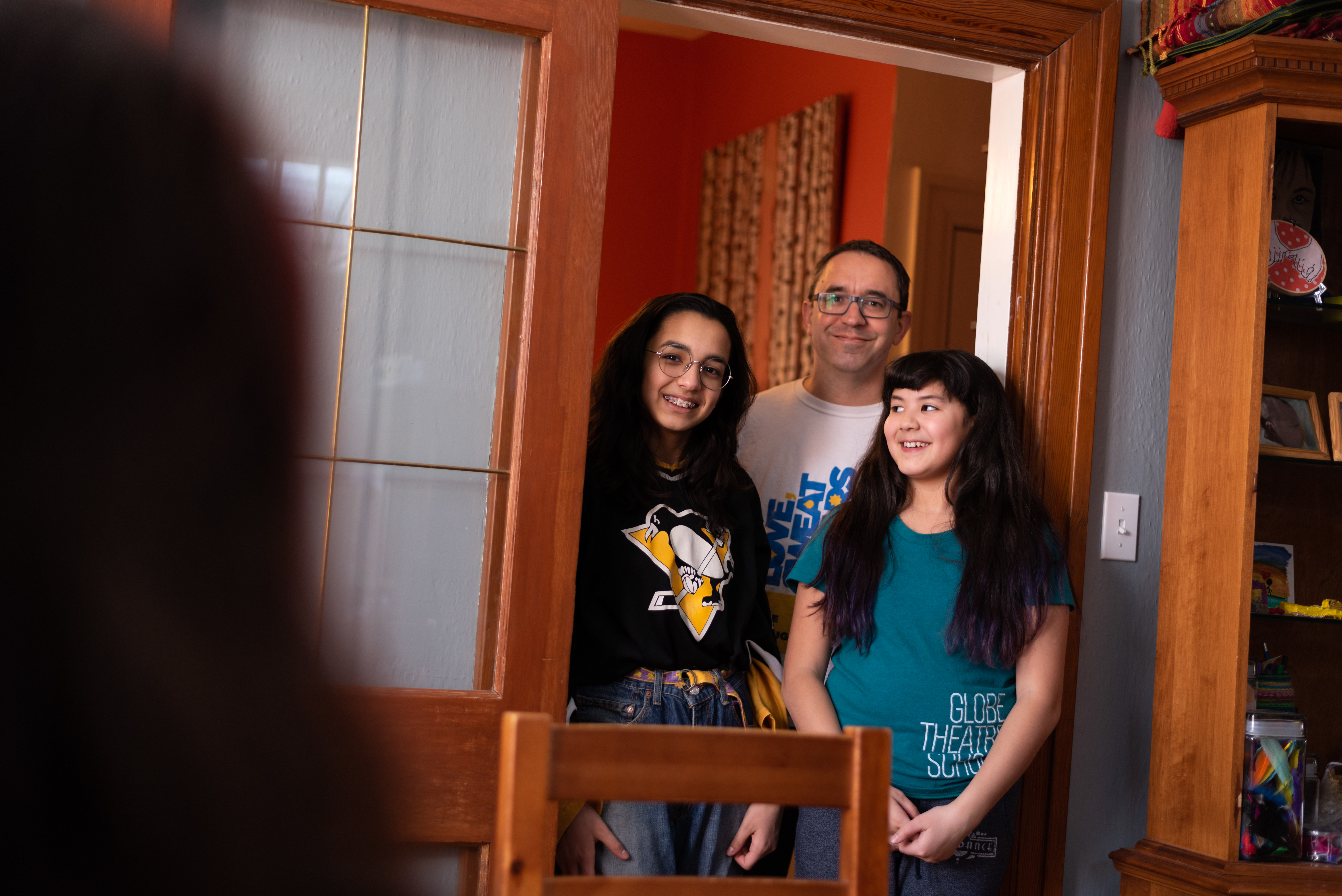 Pictured (left to right) is Kris Alvarez's daughter Zo‘ James, husband, Eric James, and daughter Iris James at their home in Regina (Michael Bell). 