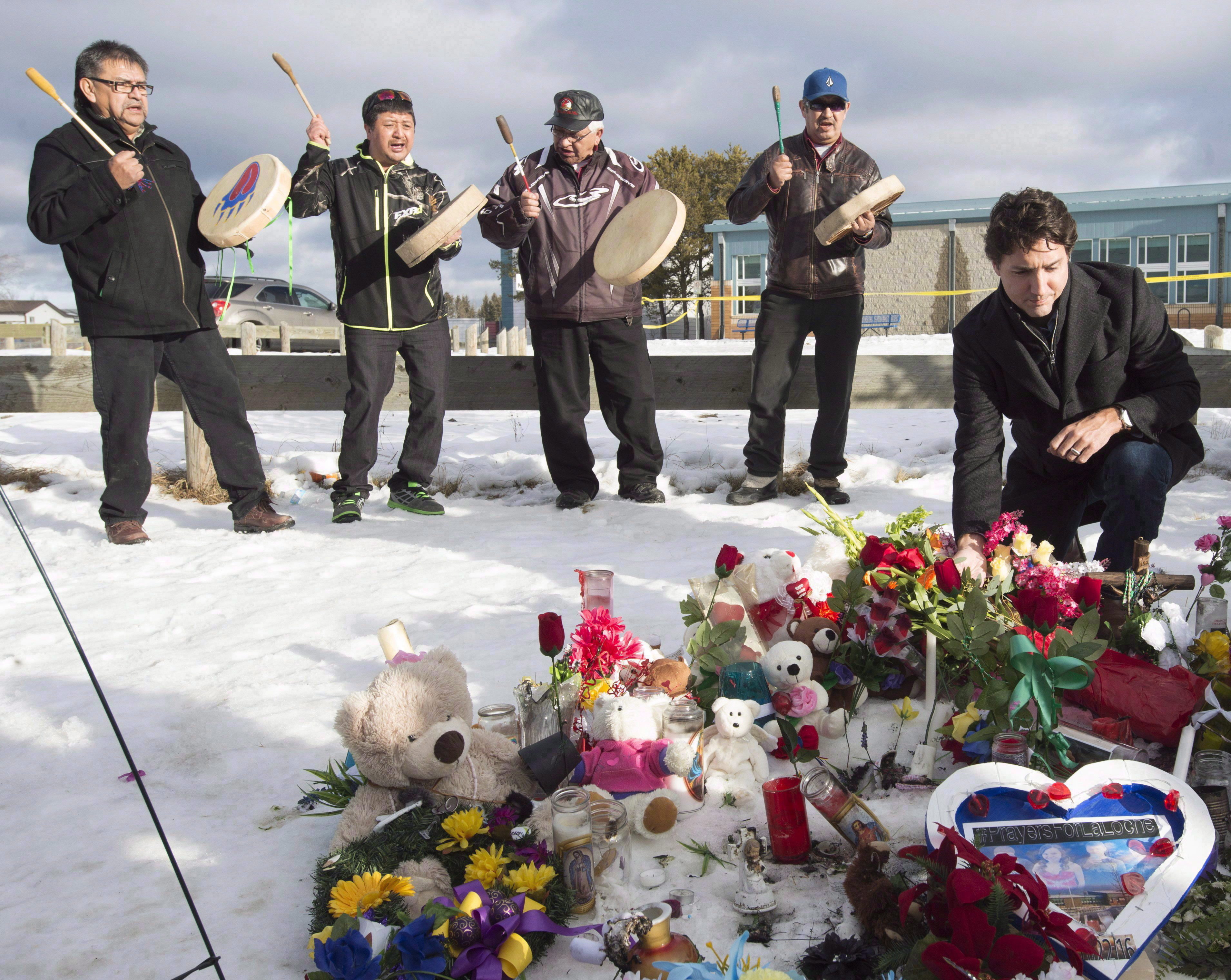 Prime Minister Justin Trudeau pauses for a moment as he lays a wreath outside the La Loche Community school in La Loche, Sask., on Jan. 29, 2016. (Jonathan Hayward/The Canadian Press)