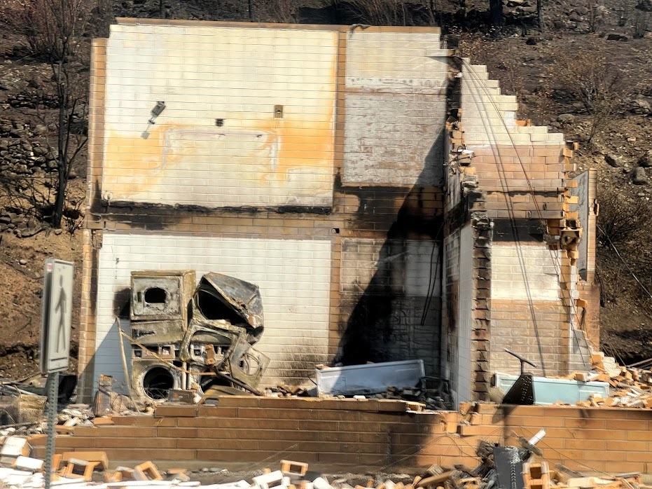 The remains of laundry machines stand in the ruins of a building in Lytton, B.C., on July 9, 2021. (Bethany Lindsay/CBC News)