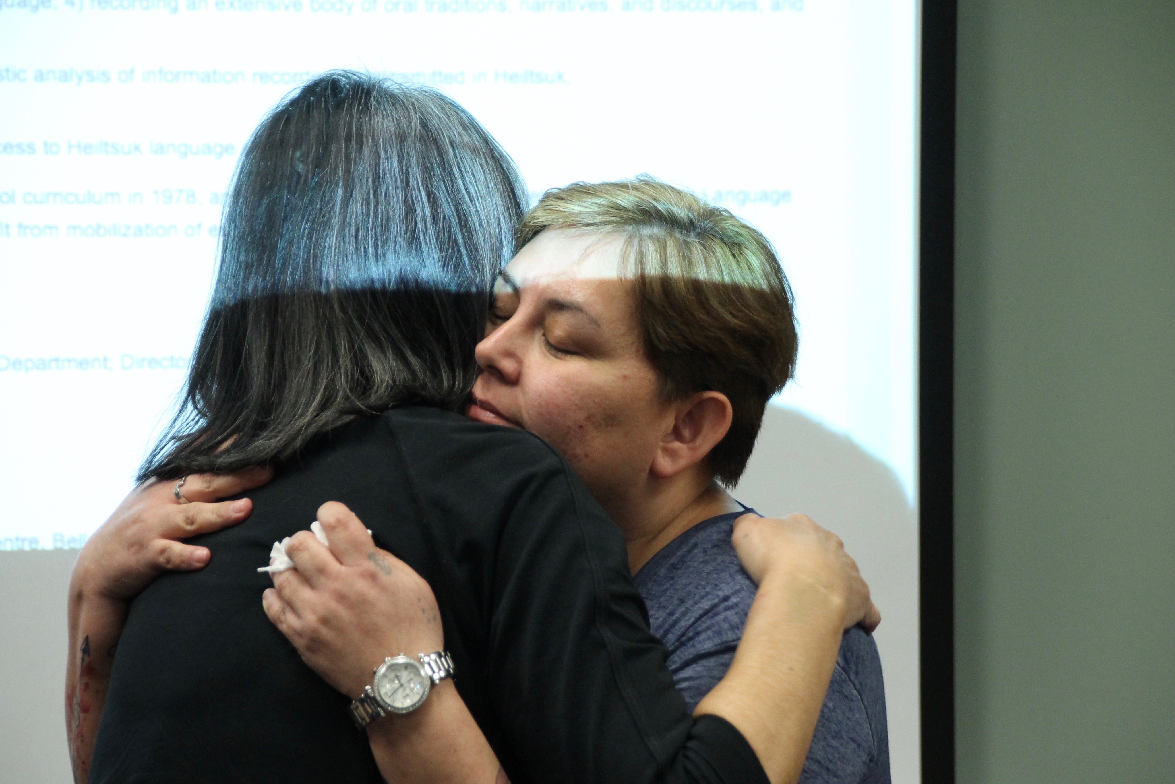 Instructor Elizabeth Wilson, right, embraces student Wanda Christianson at a Hailhzaqvla class in Vancouver. (Rehmatullah Sheikh/V.S. Wells)