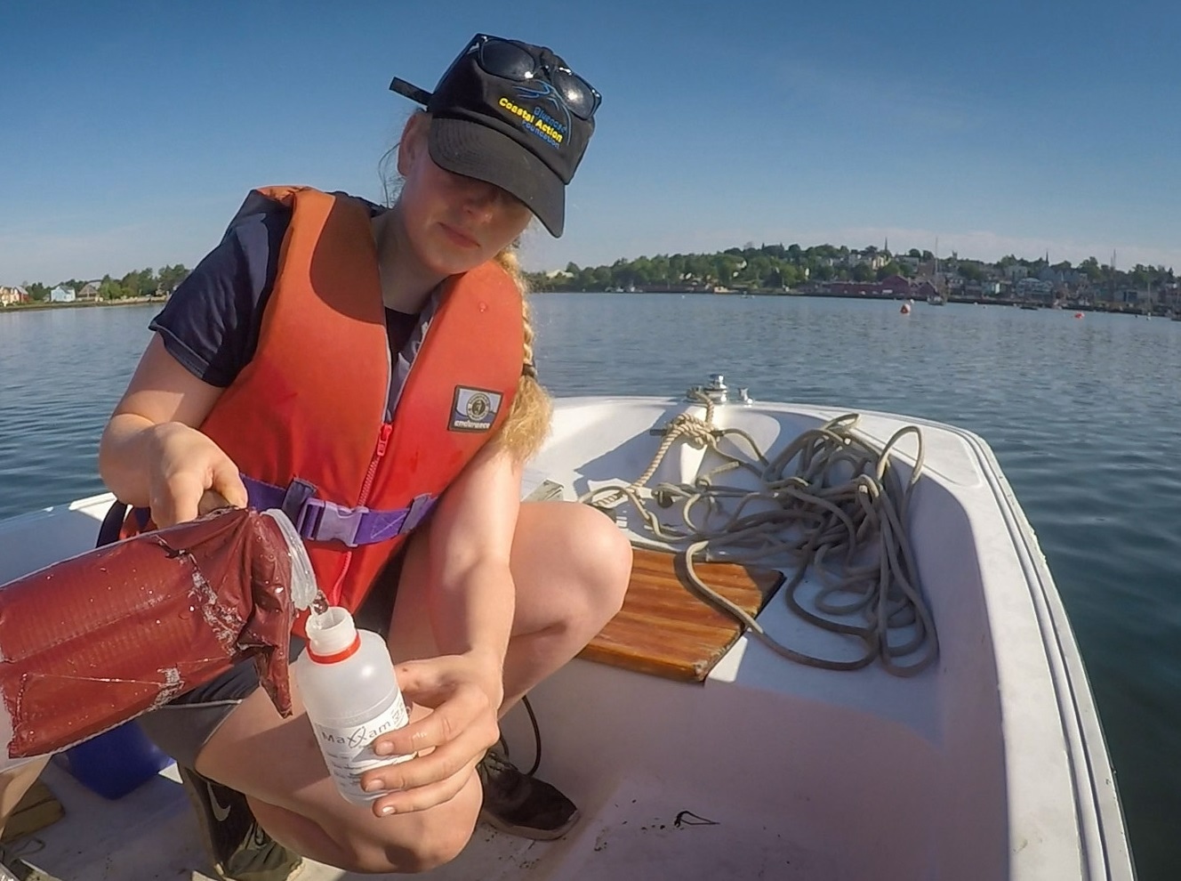 Sarah MacLeod with Bluenose Coastal Action takes a water sample. (Craig Paisley/CBC)