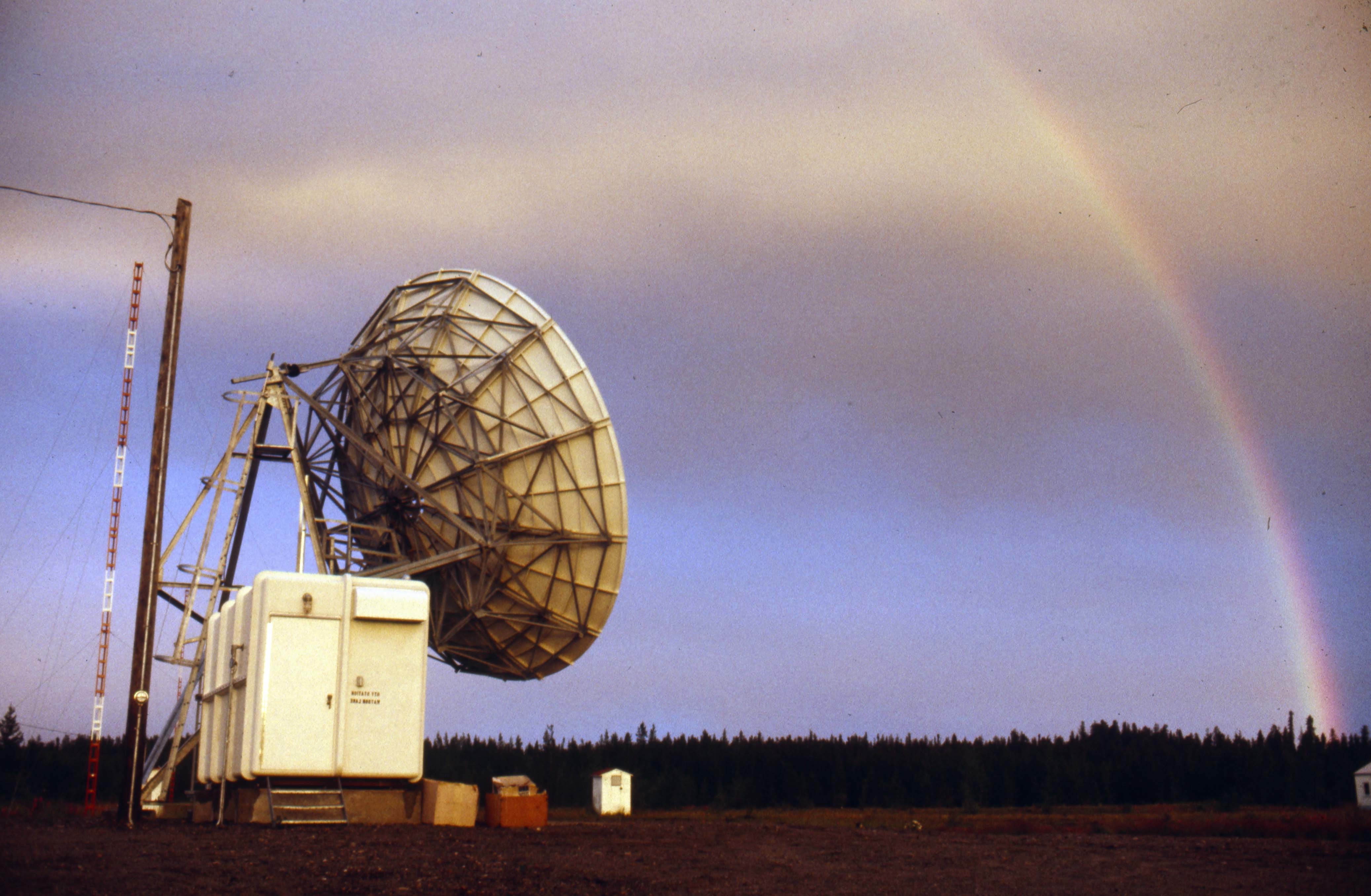 A rainbow shines over a Telesat dish and TV tower in Yukon. (Tim Kinvig)