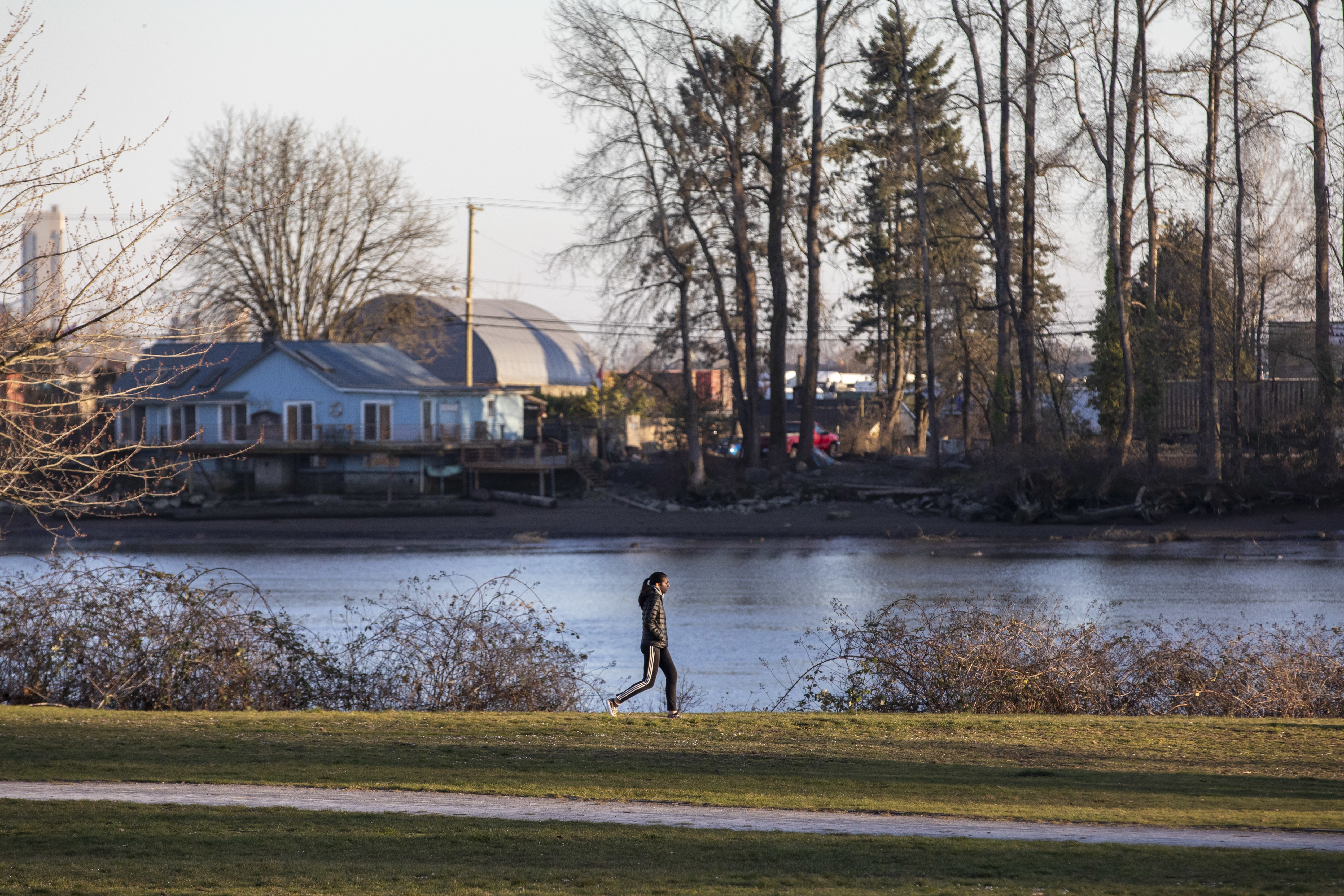 A person walks along the Fraserview Foreshore Trail in the River District. (Ben Nelms/CBC)