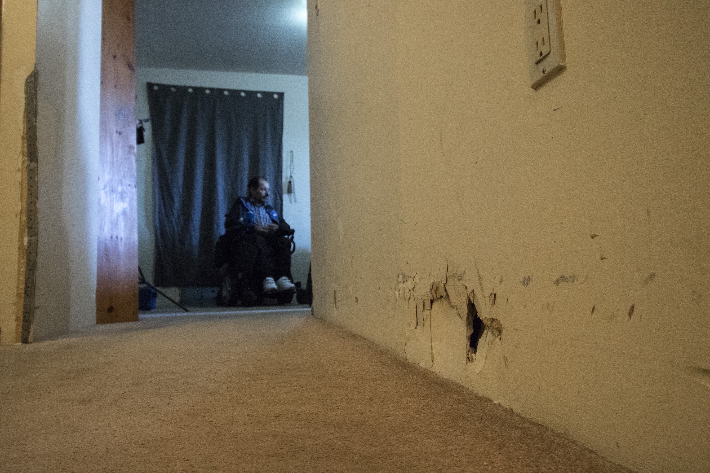 The hallway leading to the living room. Mohammad is seen in the background. (Dave Irish/CBC)