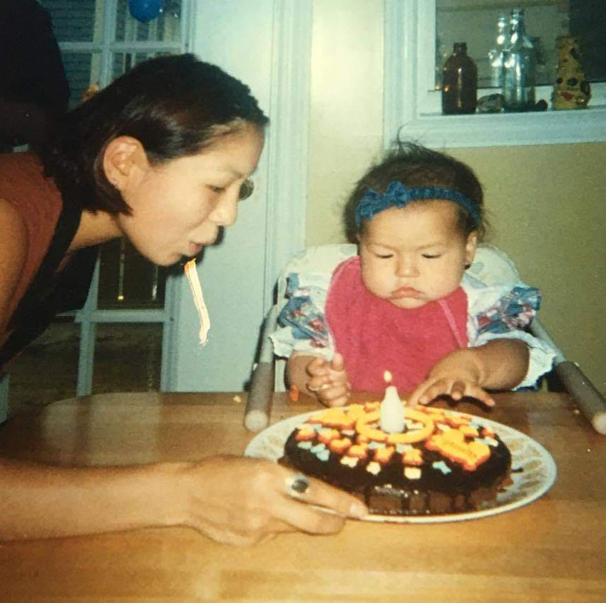 Mary Evans Harlick helps Amena blow out her candles on her first birthday. (Submitted by Amena Evans Harlick)