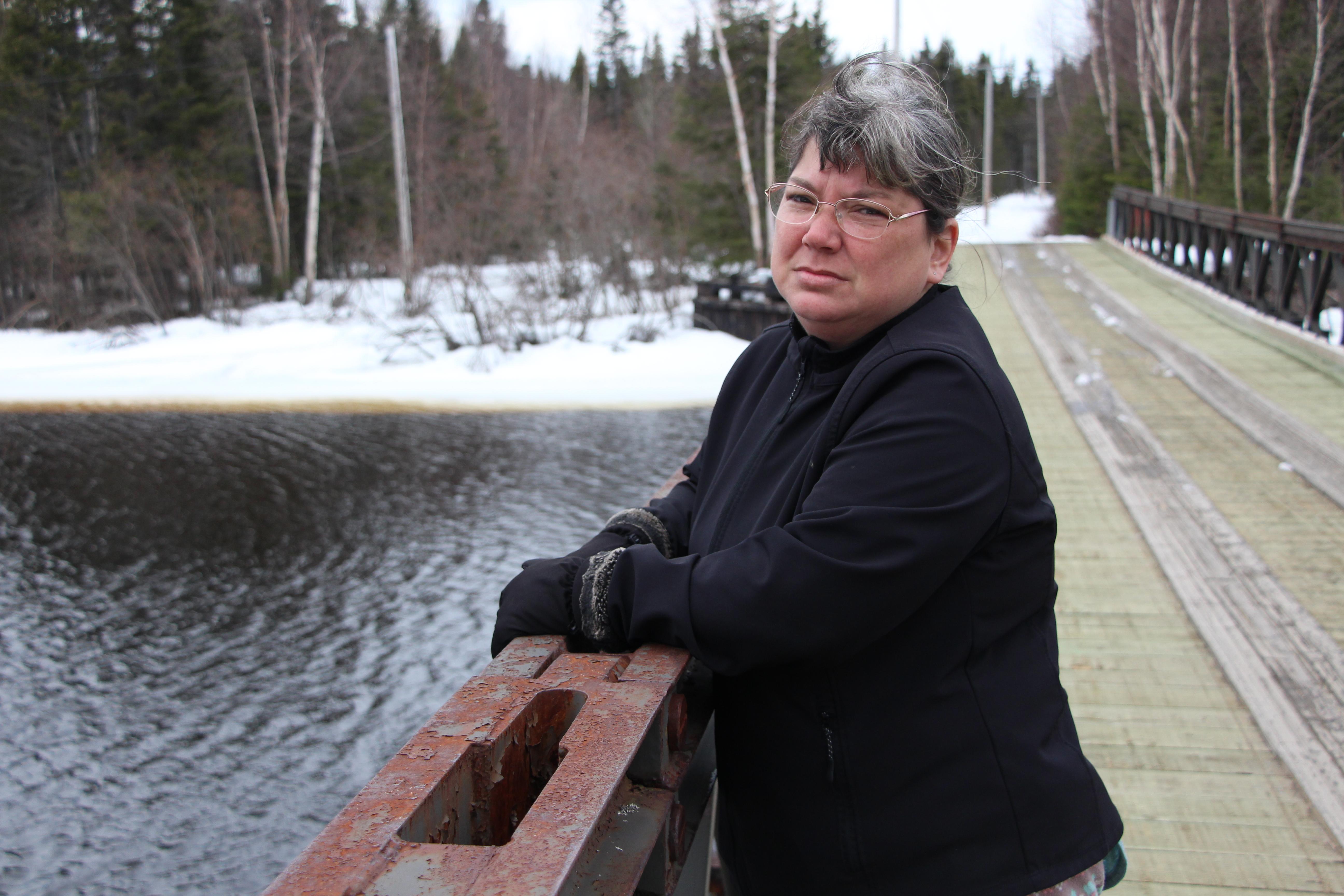 Melissa Best stands on the Wallace McLean Bridge in Mud Lake, Labrador. (John Gaudi/CBC)