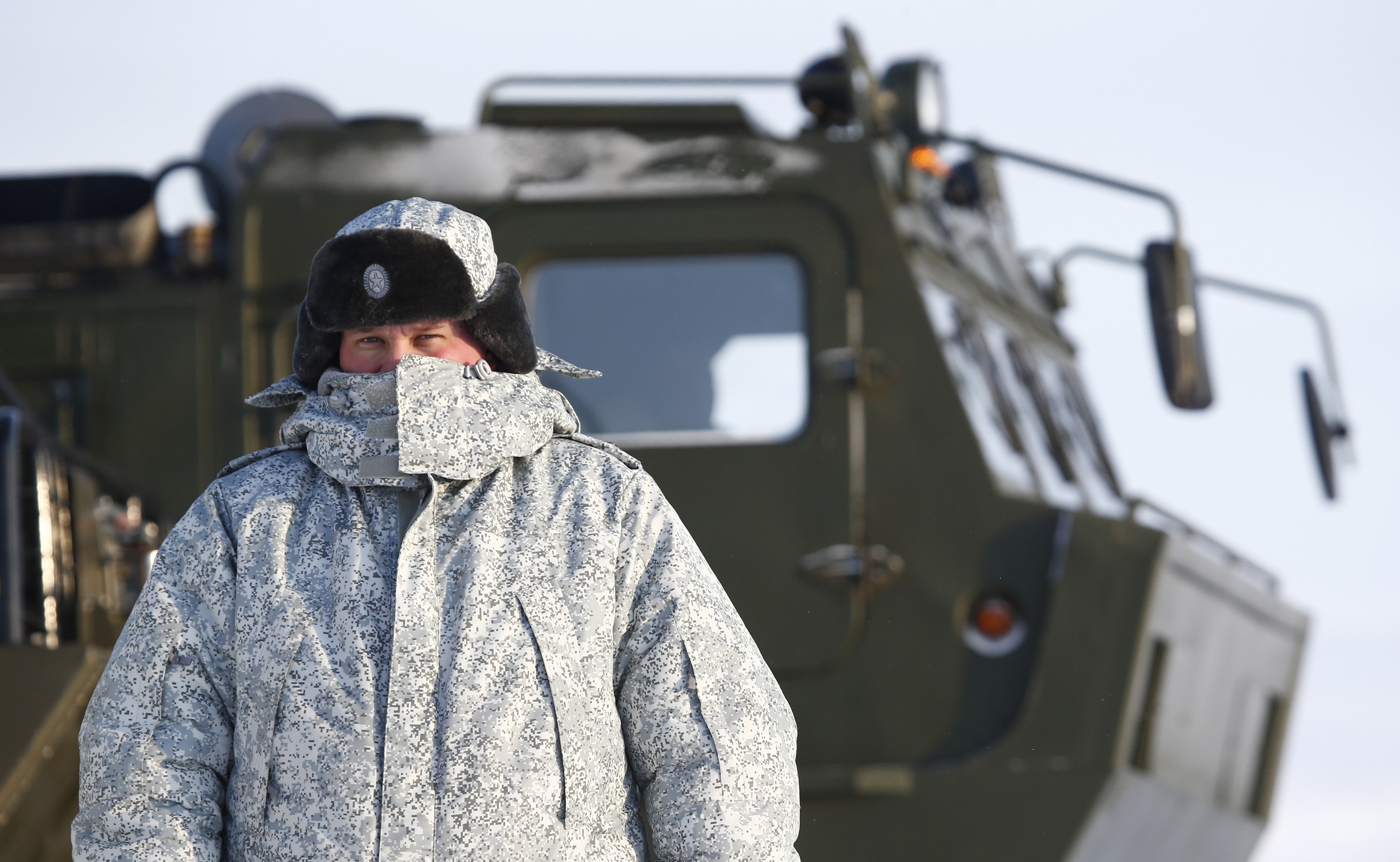 A Russian serviceman stands in front of an off-road military vehicle at the Nagurskoye military base in Alexandra Land on the remote Arctic archipelago of Franz Josef Land. (Sergei Karpukhin/Reuters)