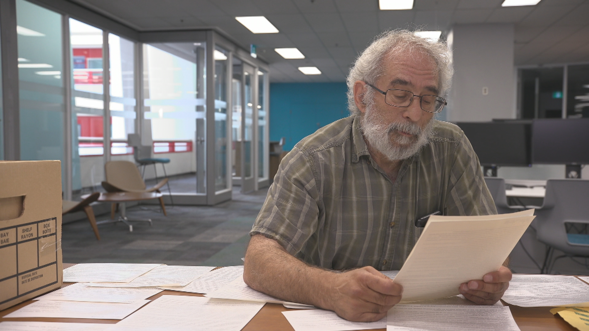 Journalist Mike Moralis reviews his old files from his investigation into Grenville Christian College. (Jonathan Castell/CBC)