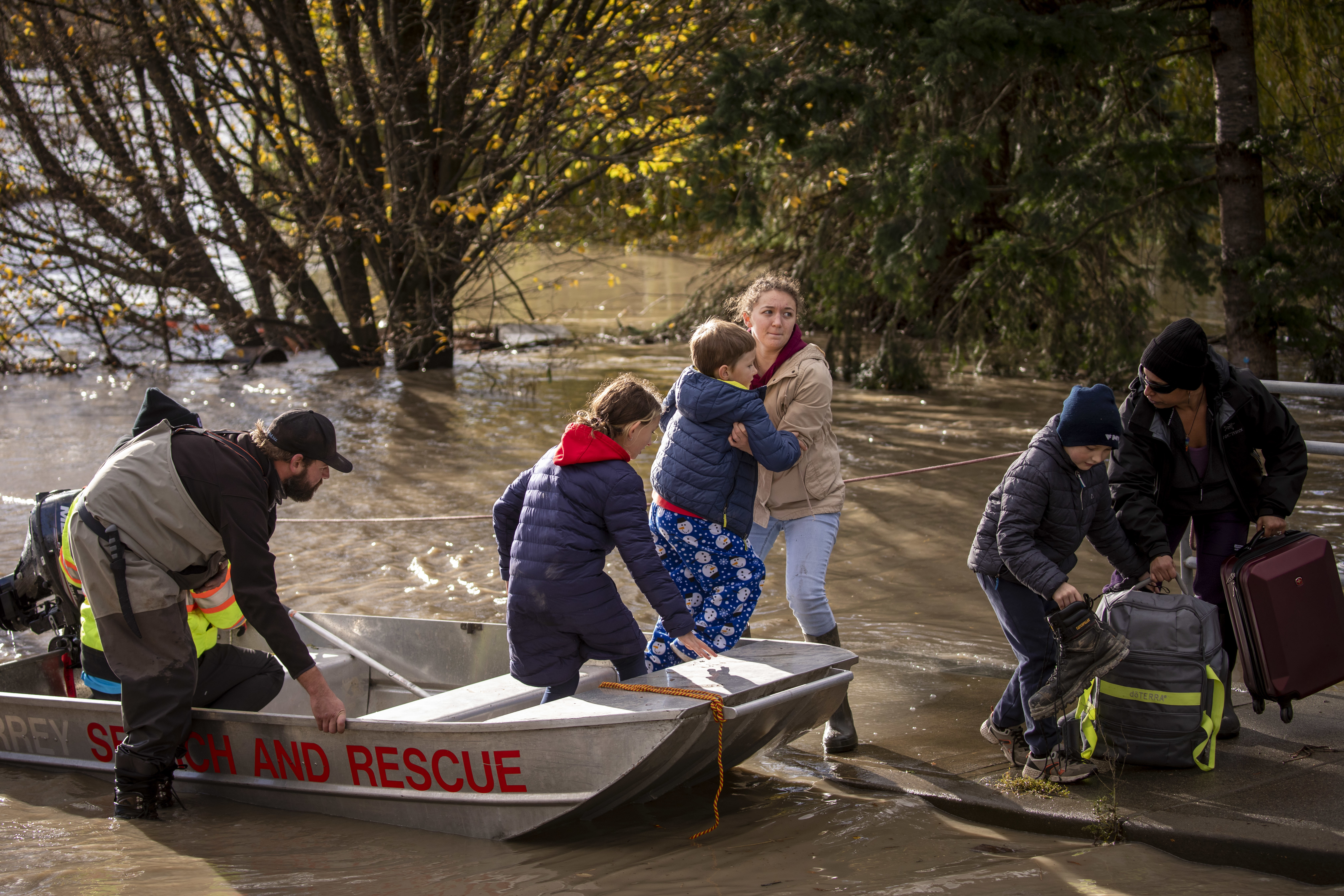 People are transported on a boat after being rescued from an area that was cut off due to flooding in Abbotsford, British Columbia on Tuesday, November 16, 2021. (Ben Nelms/CBC Vancouver)