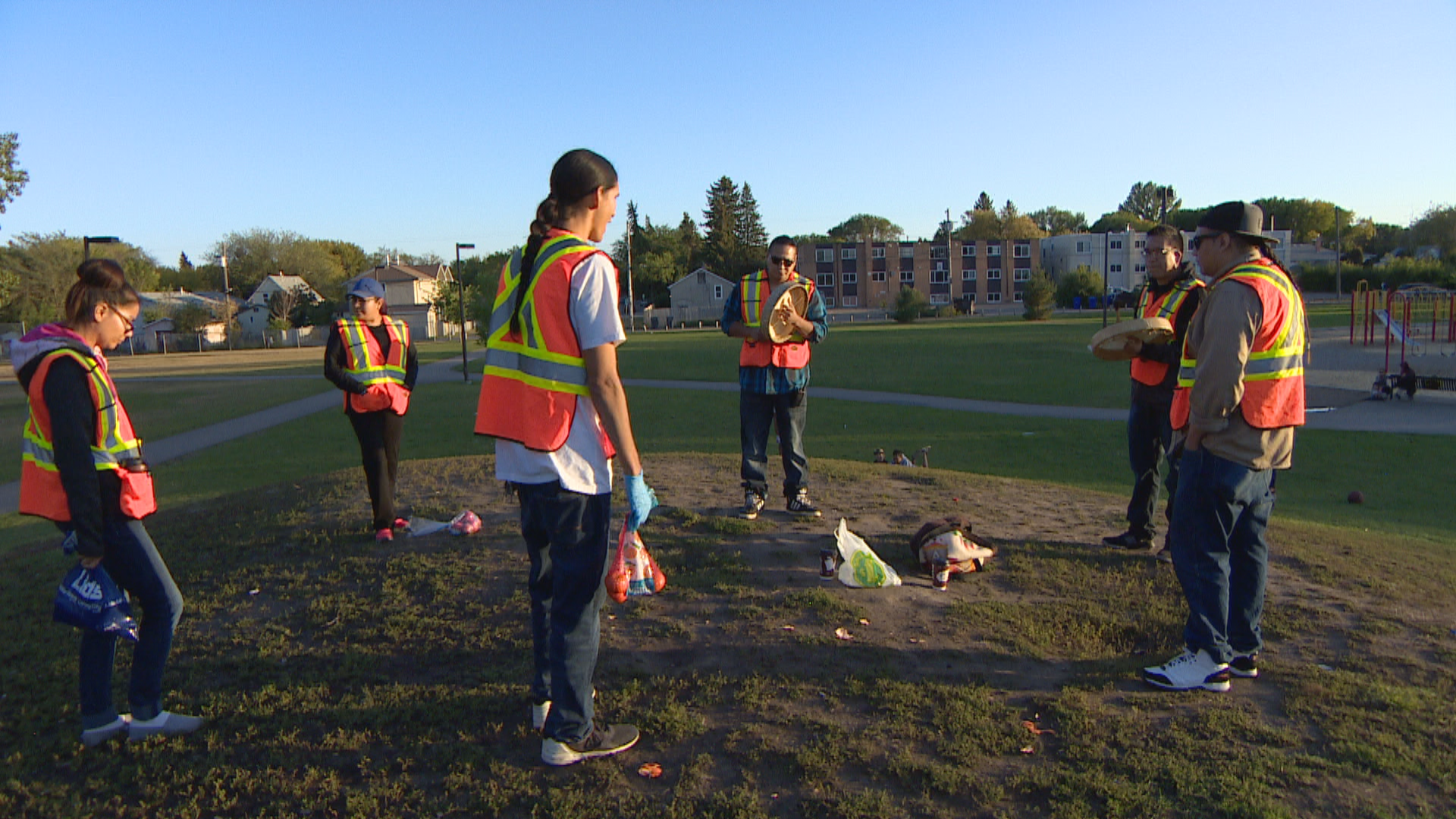 Okihtcitâwak Patrol Group sing a round dance song in preparation for a night of patrolling. (Penny Smoke/CBC)