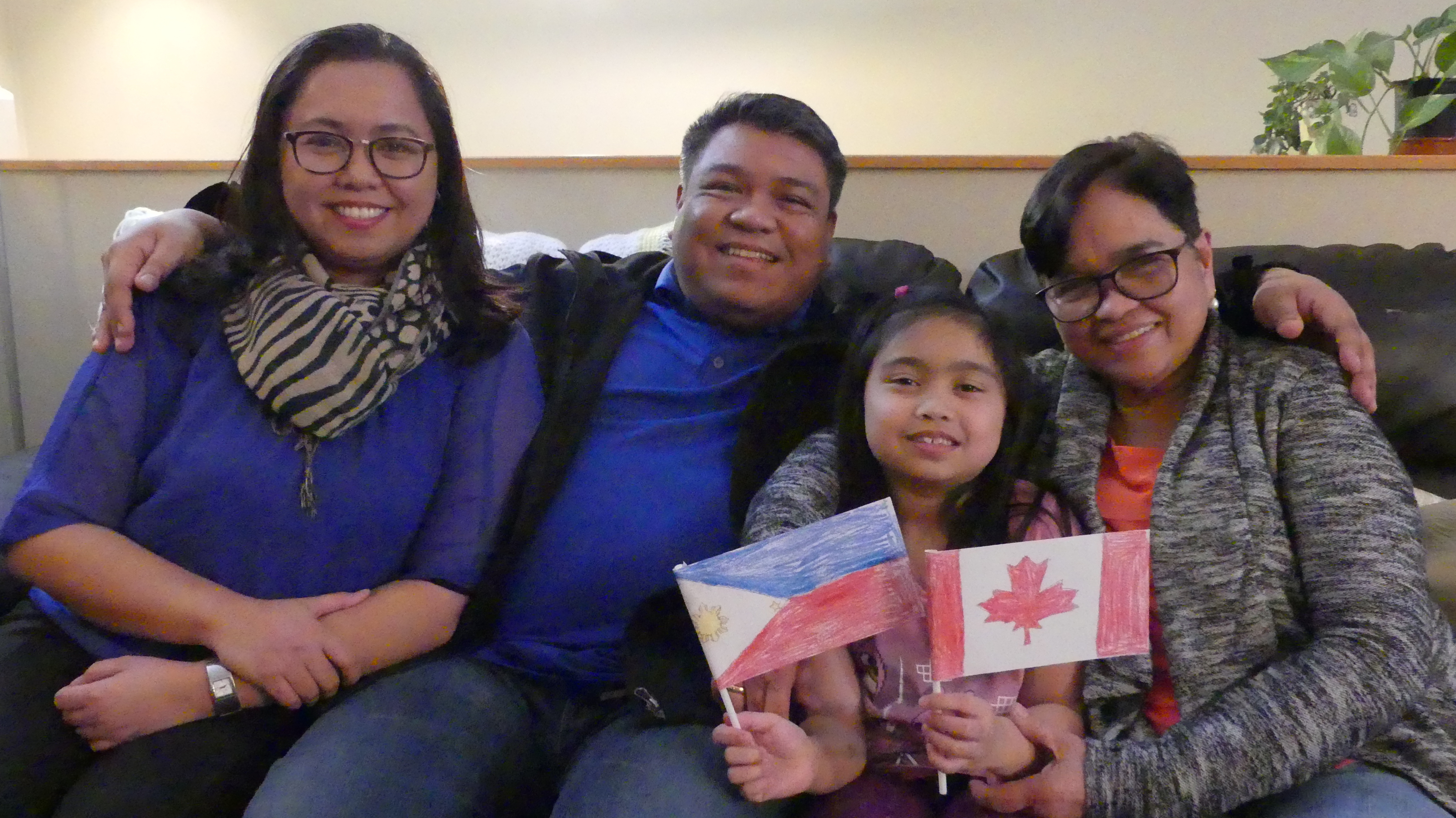 Peegy Ontong sits with her husband, Krispin, their seven-year-old daughter, Lexie, and Kris's mother, Angelita, in their shared home in Steinbach, Man. They've all lived together since Angelita moved to Canada, sponsored by Peegy, in 2017.