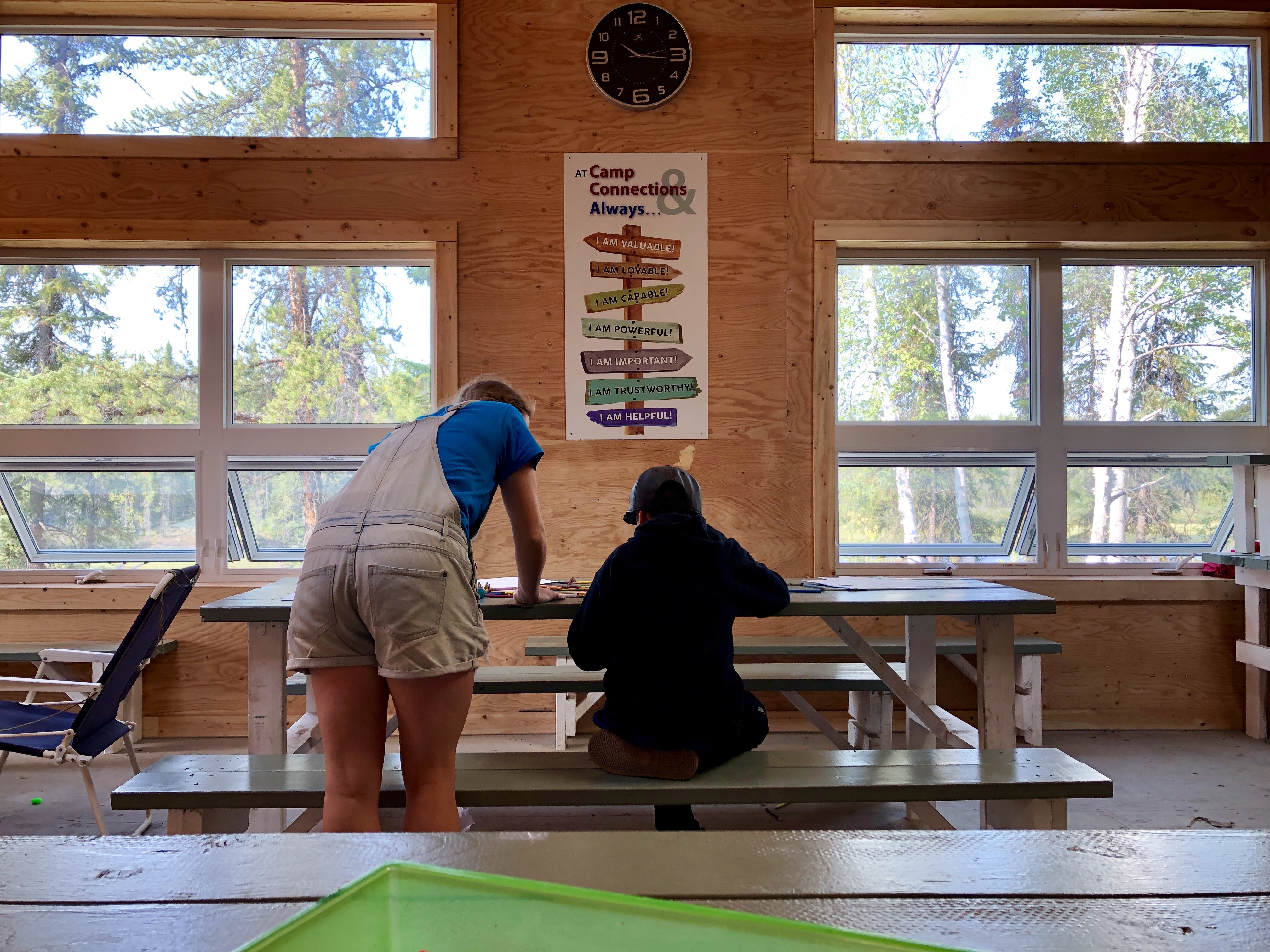 A camp counsellor works with a youth at Camp Connections, a summer camp for foster children outside Yellowknife. (Kate Kyle/CBC)