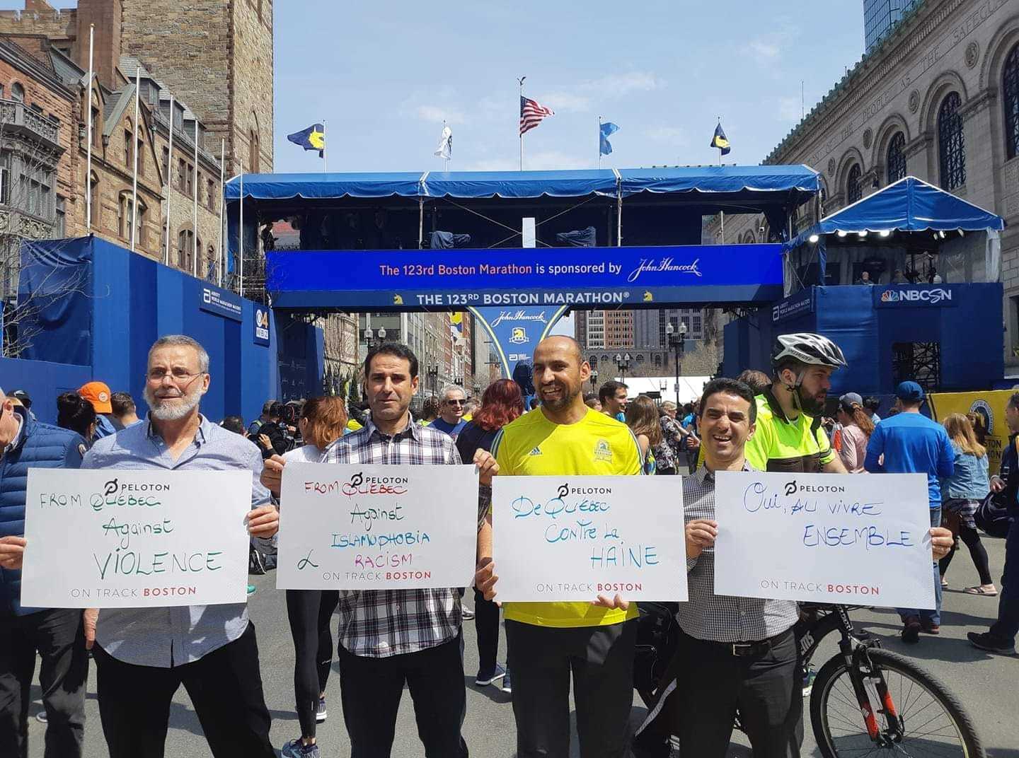 The day before the race the four men stood in front of the finish line in Boston with messages of peace. (Submitted by Abdelhak Achouri)