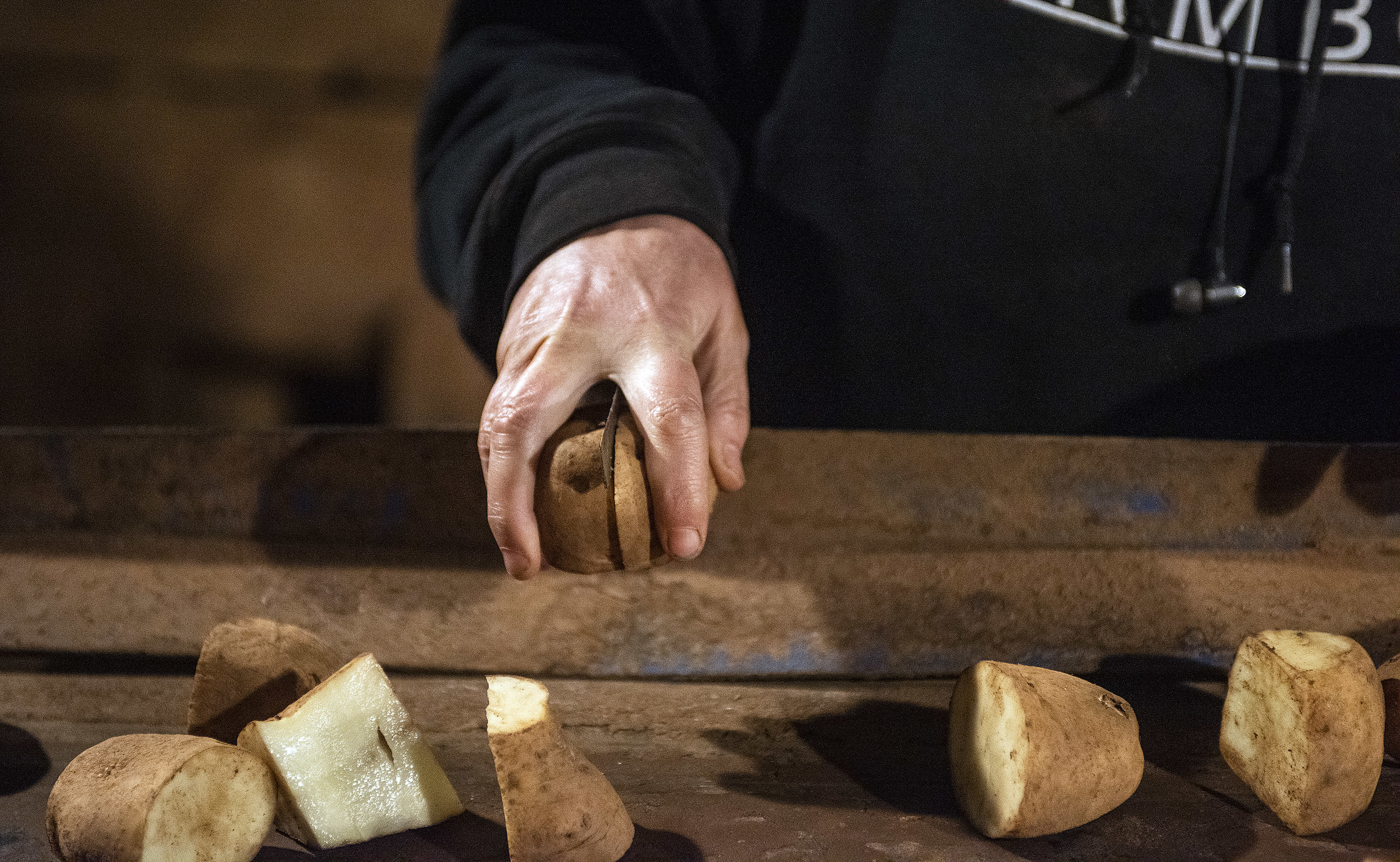 An employee of Farm Boys Inc. cuts seed potatoes in preparation of planting. (Brian McInnis)