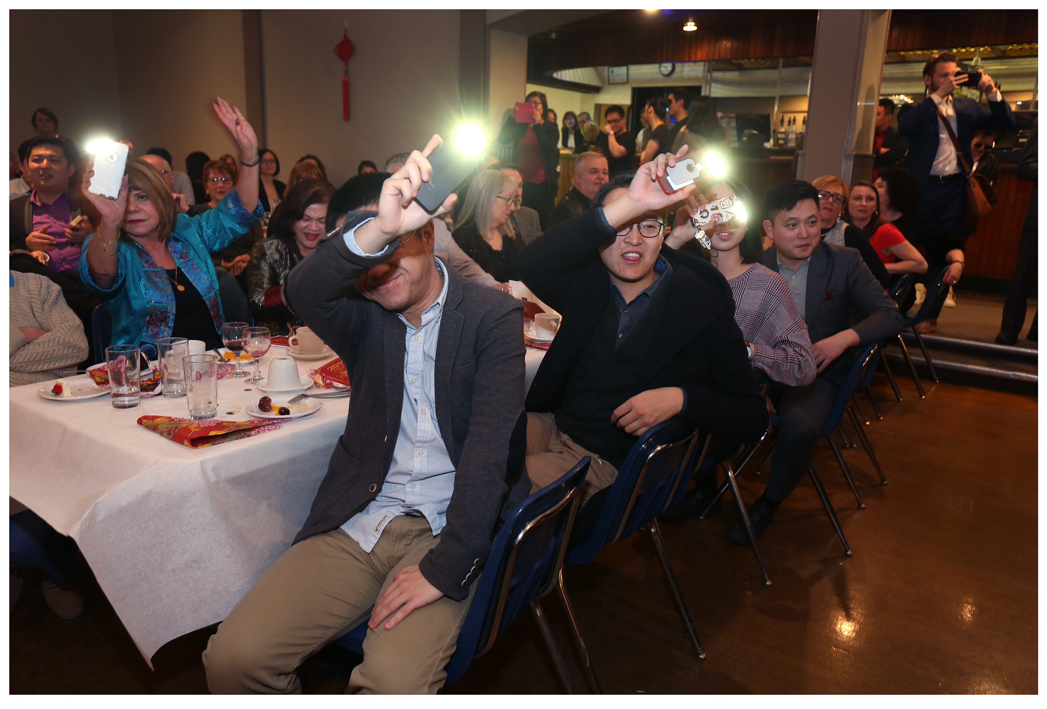 Attendees used the lights on their phones to show their appreciation for performers during the night's celebrations. 