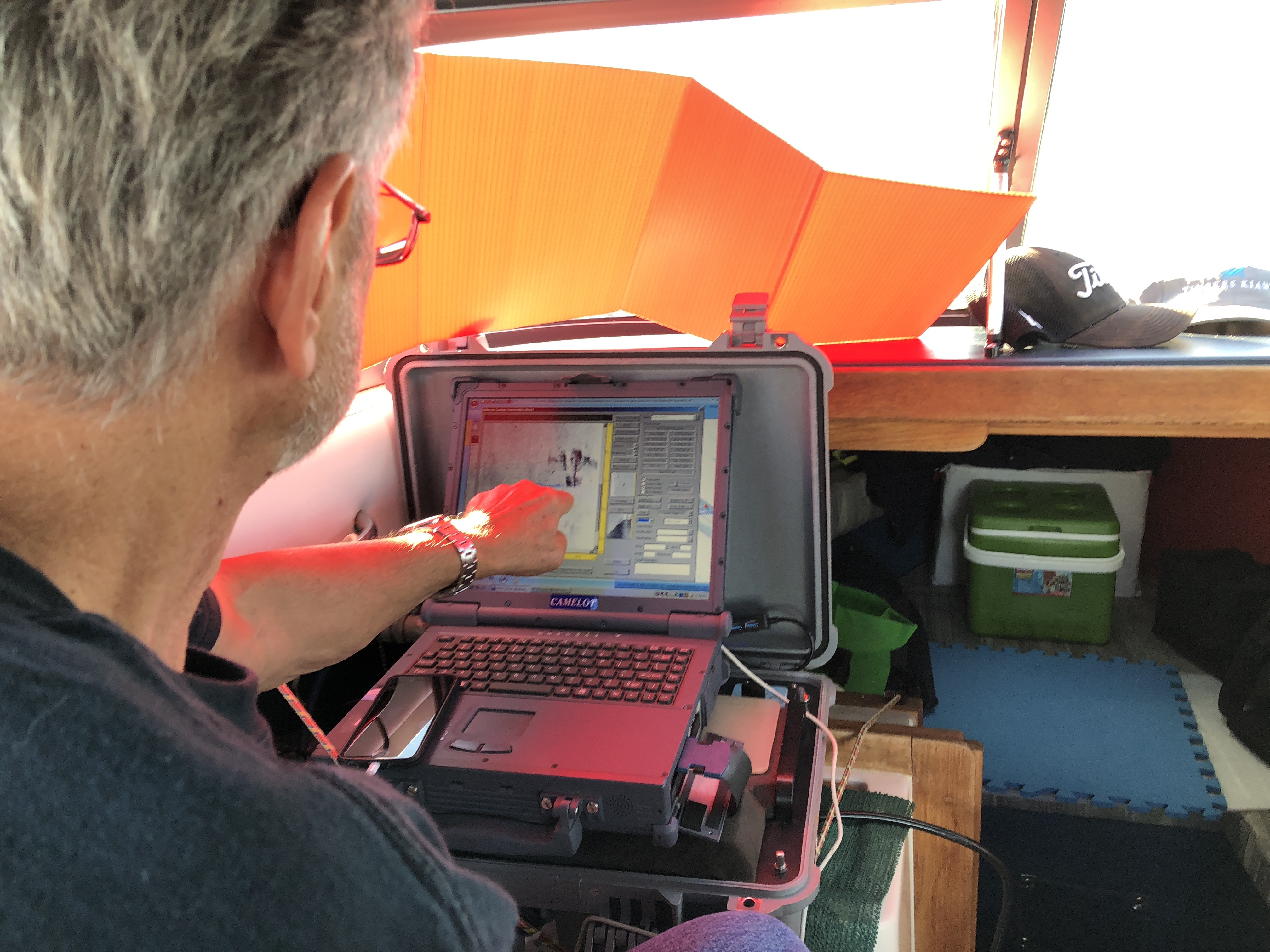 Garry Kozak reads out the information on the sonar when the plane had been located. Kozak said he gave a lot of credit to the Kapusta couple. “They’re sort of unique people to take on a challenge like this to try and finally define where Linda’s father had died.” (Submitted by Donald Kapusta)]