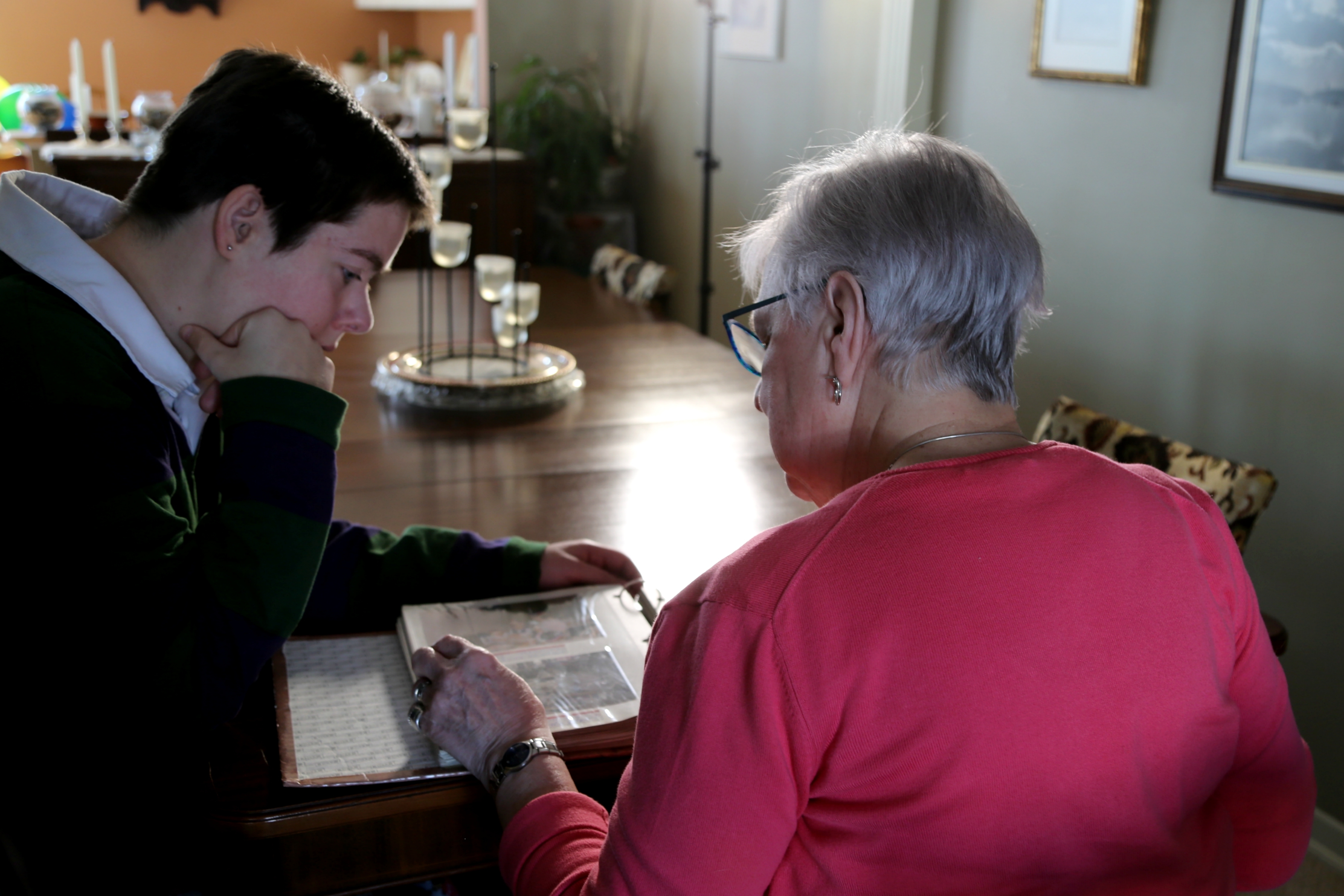 Jennifer Graves-Smith, left, and her mother, Rose Marie Smith, look at family photos in their Halifax-area home. (Karissa Donkin/CBC)