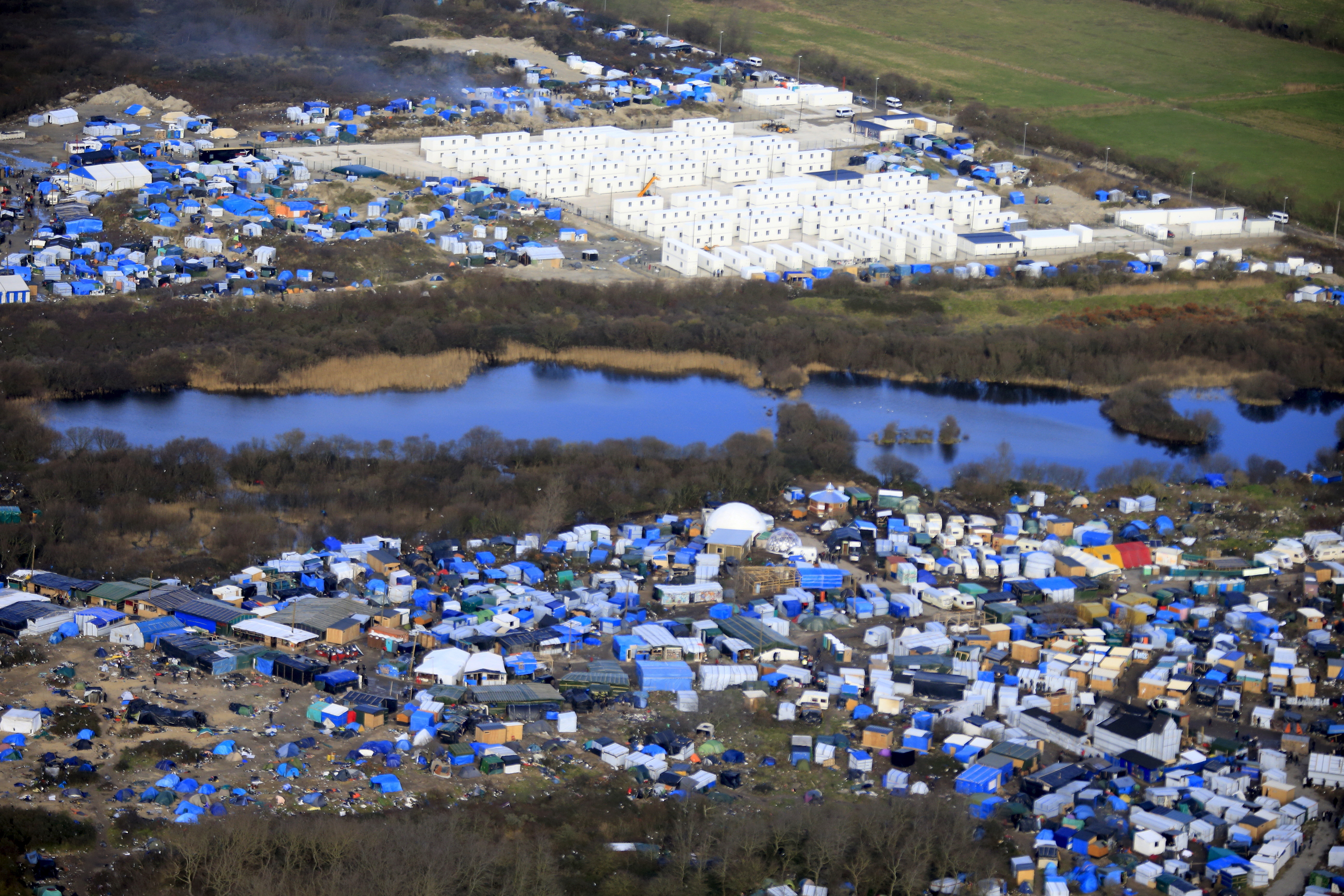 Aerial view of a makeshift camp as containers (rear) are put into place to house several hundred migrants living in what is known as the "Jungle," a squalid, sprawling camp in Calais, northern France, on January 17, 2016. (Pascal Rossignol/Reuters)