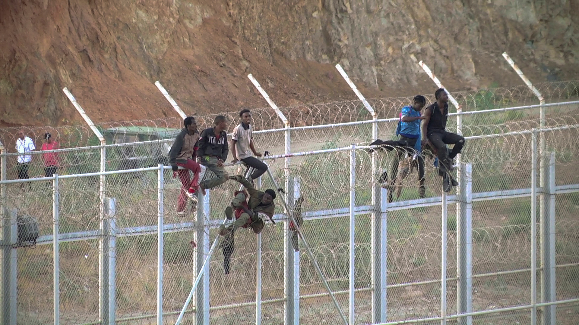 African migrants climb the border from Morocco to Ceuta, Spain, July 26, 2018, in this still image from video. (FARO TV via Reuters) 