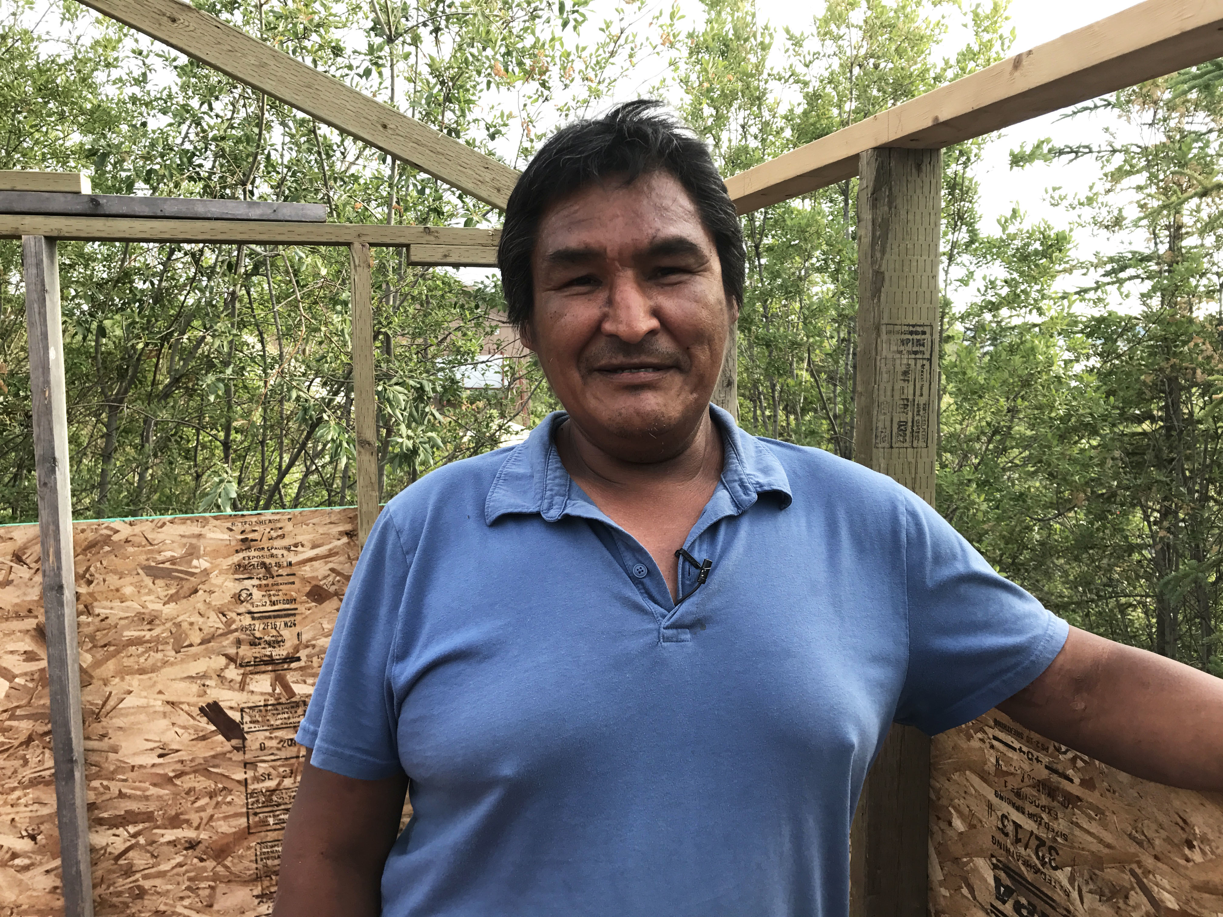 Roderick Kakfwi is unable to get a home through the N.W.T.'s housing corporation and can't afford to rent privately. He's building a tent frame for the summer months.