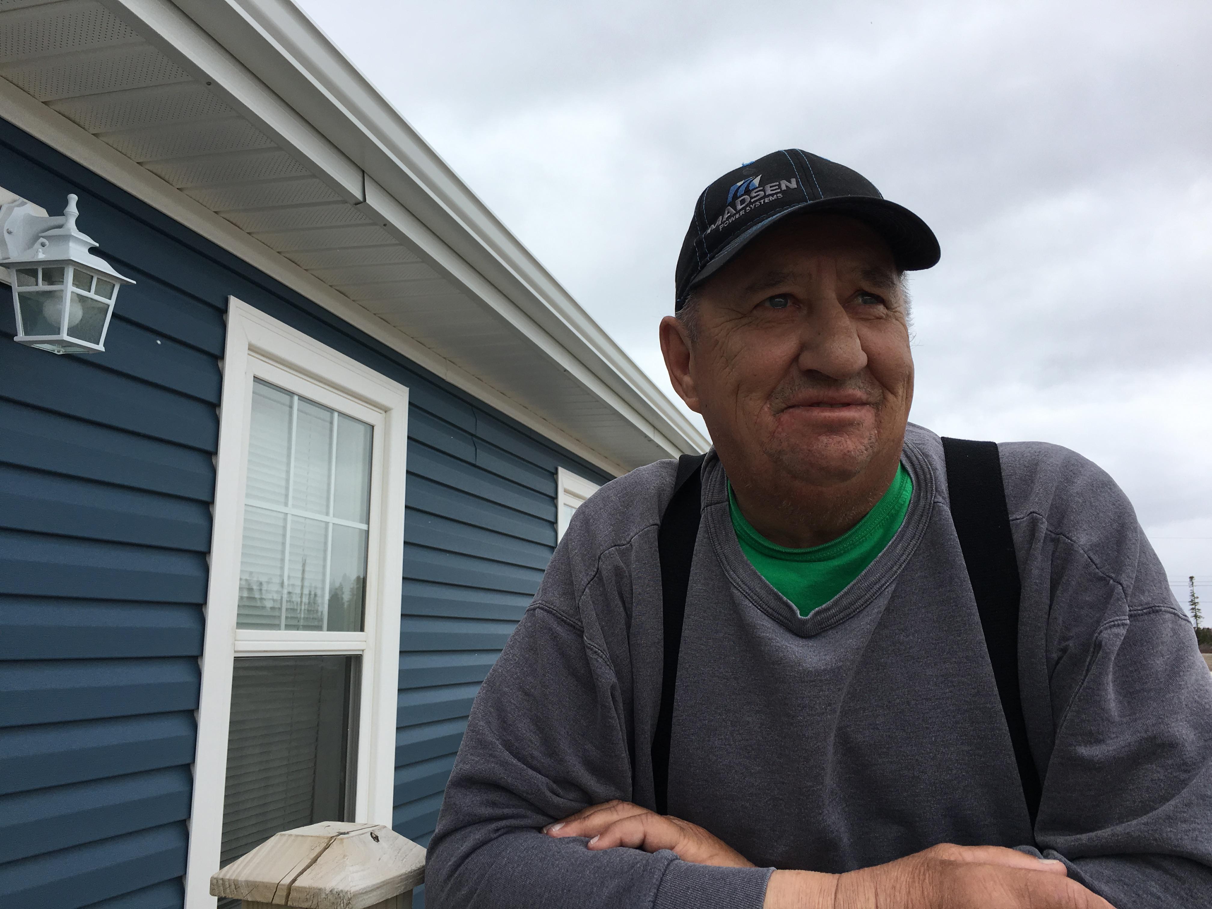 Ronnie Hopkins stands on the front step at his Brett Street apartment in Happy Valley-Goose Bay. It’s a nice place, Hopkins says, but he is eager to get home to Mud Lake.  (Bailey White/CBC)