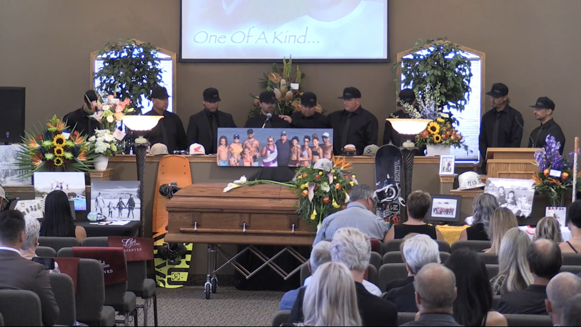 A group of male friends and family members gather side-by-side to talk about Ryan Pancoast at his funeral. (Screenshot of video by RJF Productions, submitted by Jordan Pancoast.) 