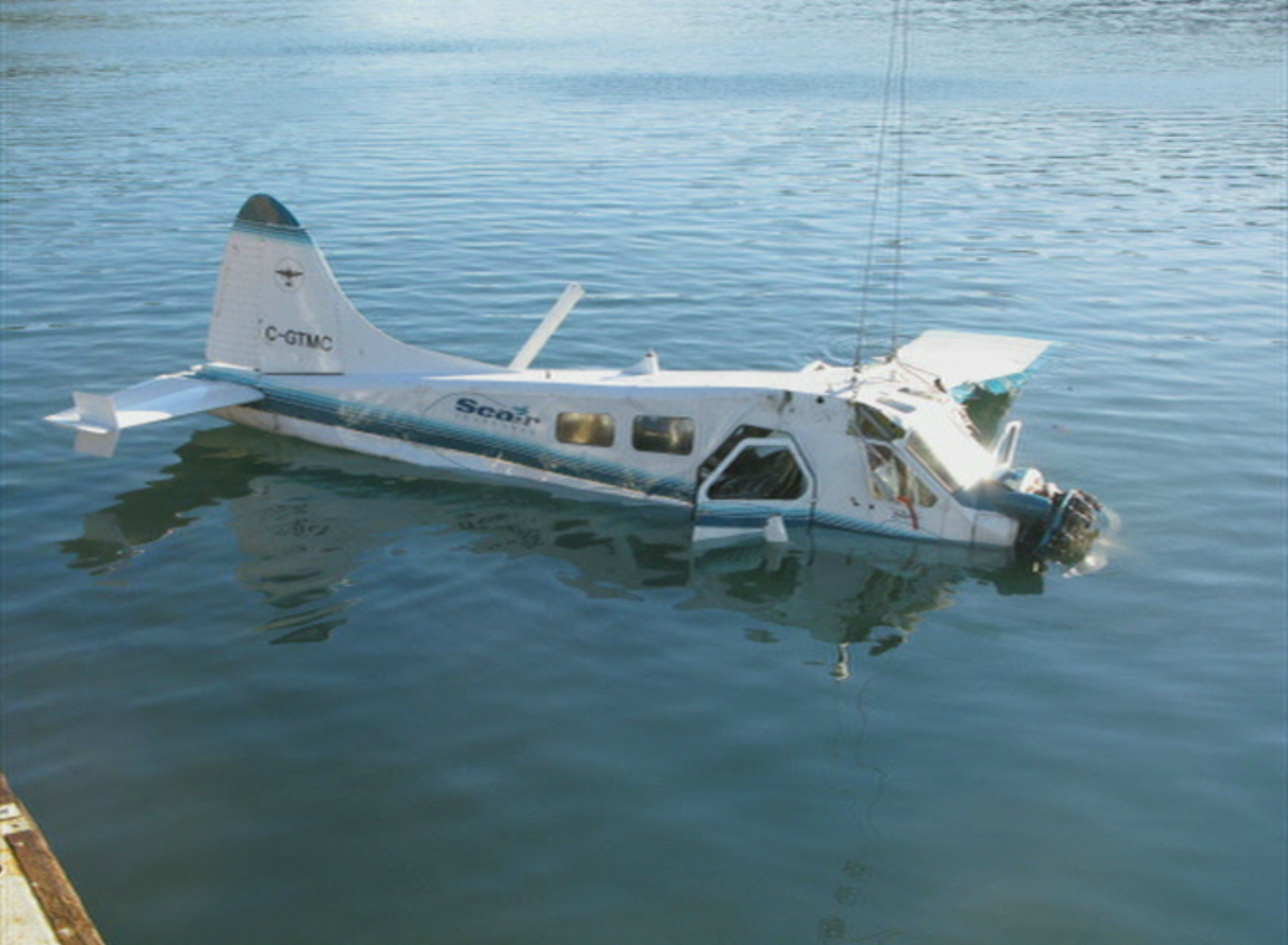 The floatplane is hoisted from the water after being recovered from the seabed. (CBC Archives)