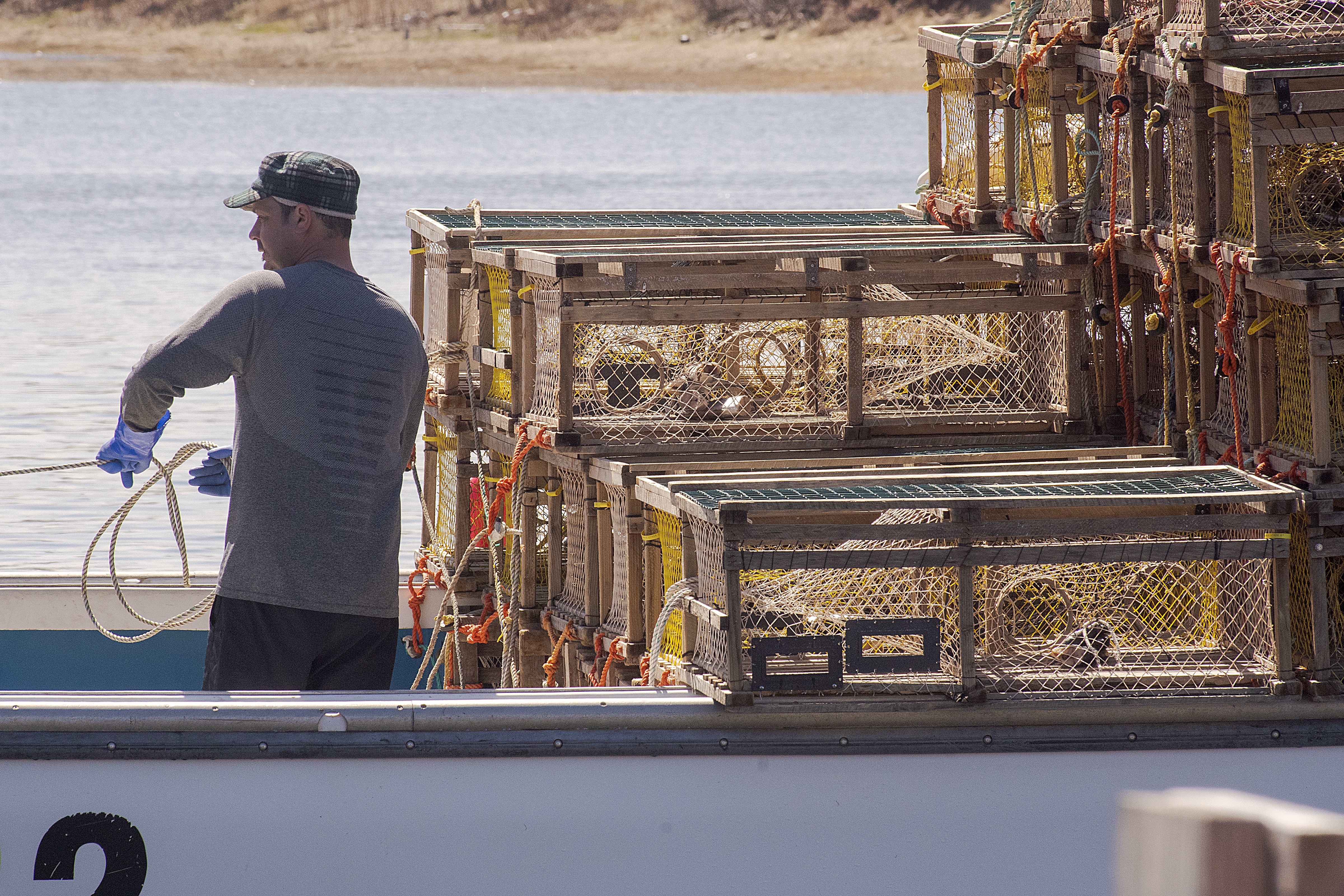 The ropes attached to the traps have to be tied in such a way it is difficult for anyone to get their feet tangled. Each trap weighs upwards of 60 pounds which could easily drag an unwary deckhand overboard. (Brian McInnis/CBC) 