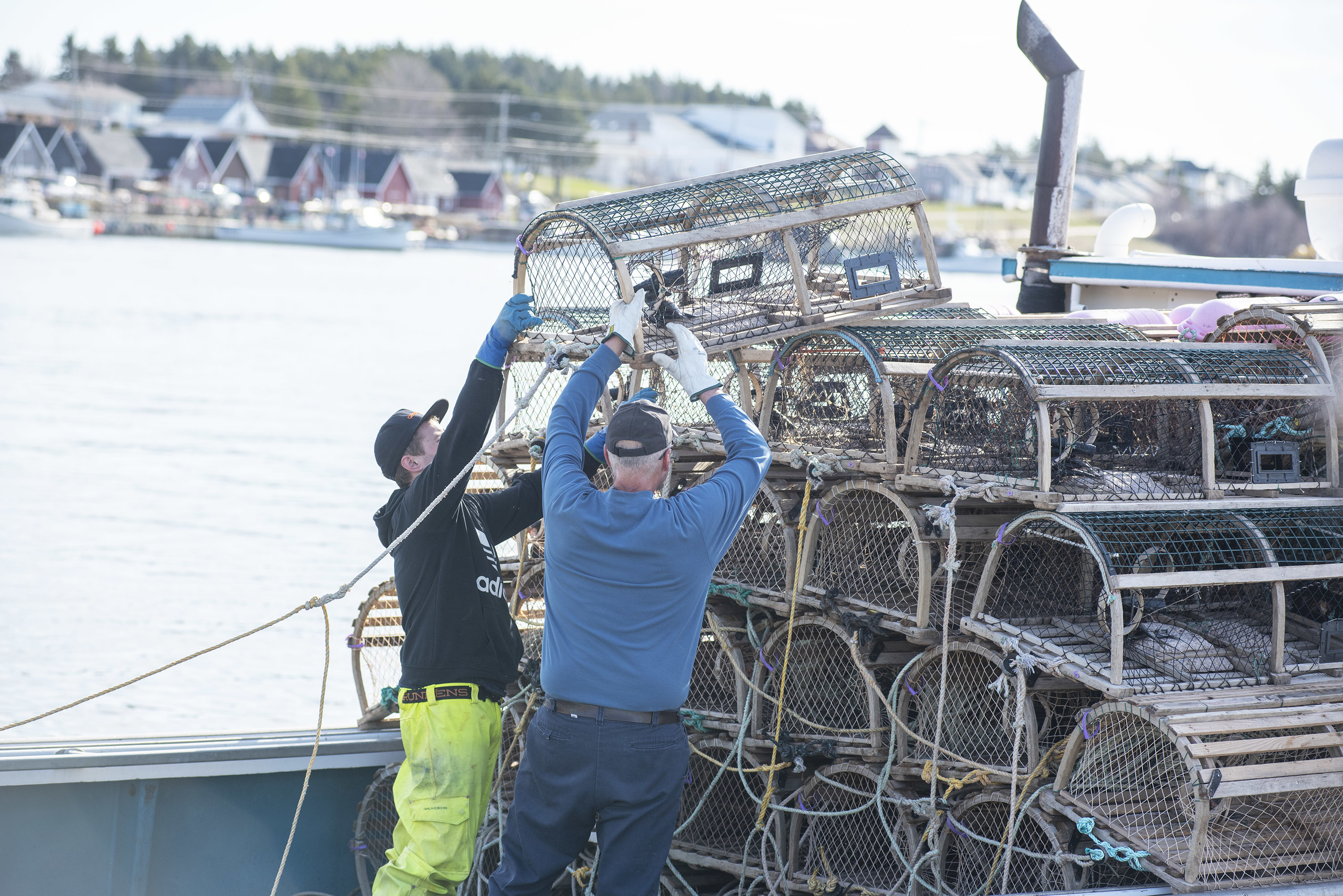 The second and last load of traps for the day is being loaded onto a boat. (Brian McInnis)