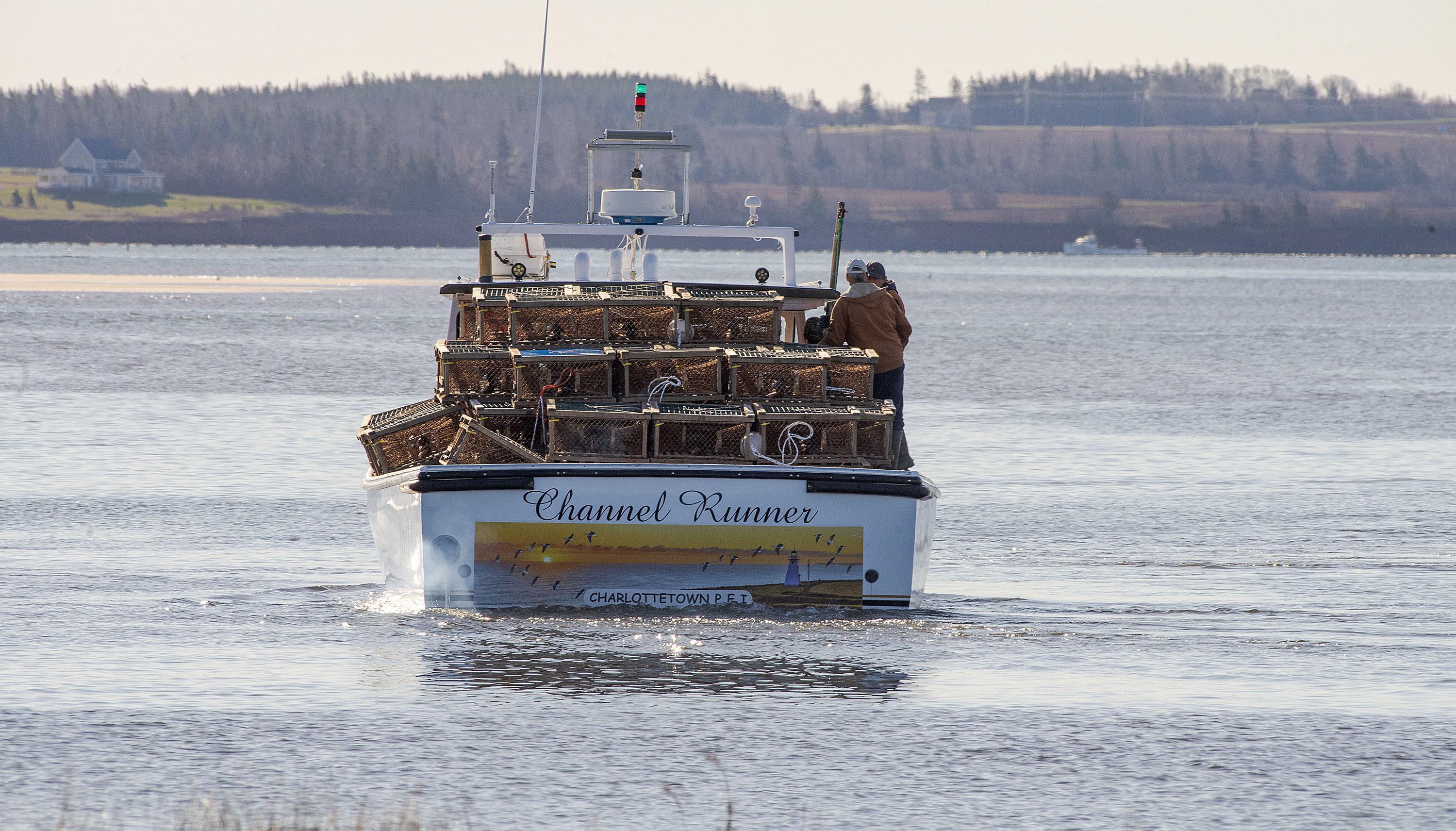 The Channel Runner, loaded with approximately 150 lobster traps, heads toward the Malpeque Harbour channel. (Brian McInnis/CBC)