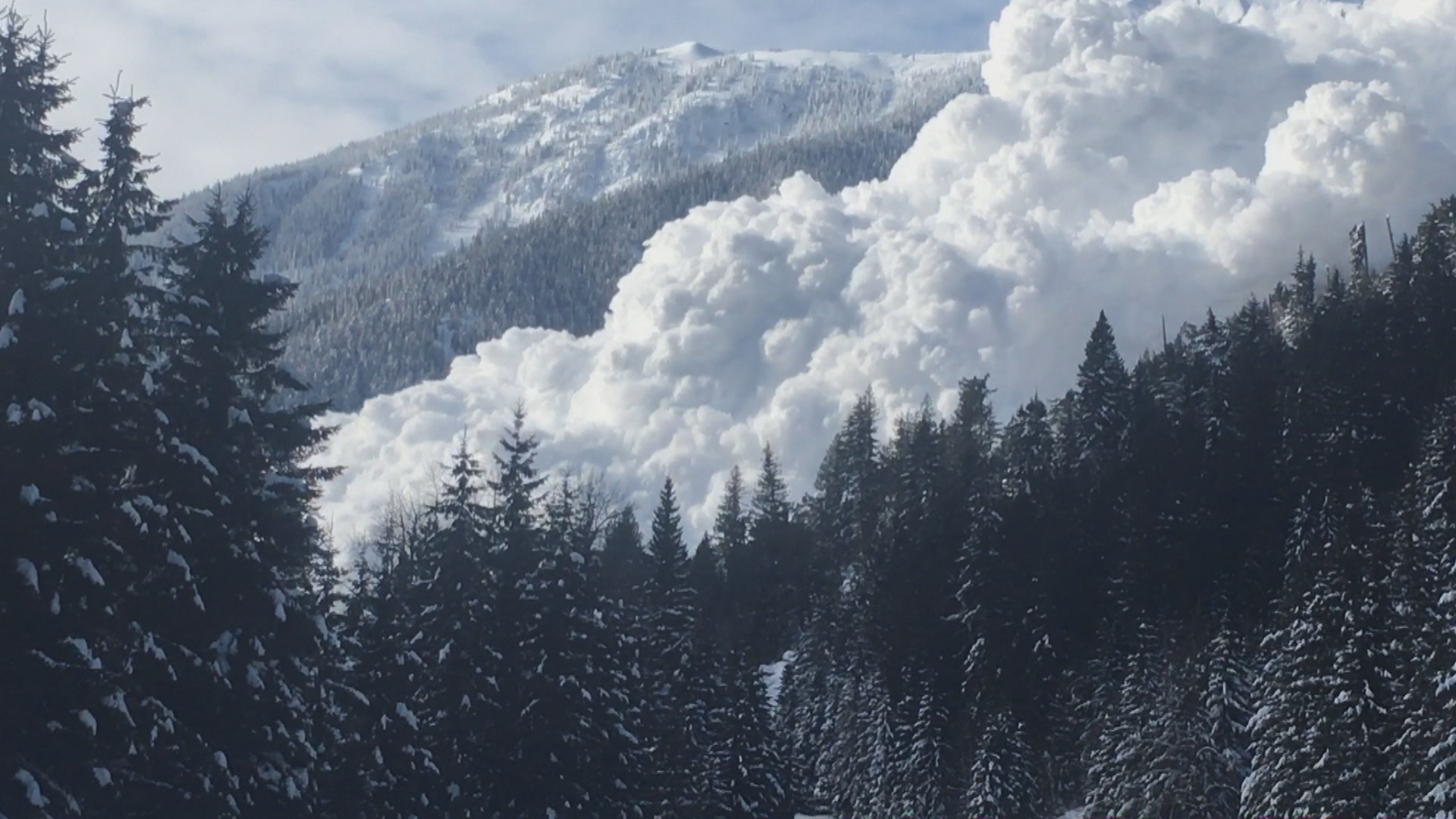 The snow comes roaring down the mountainside after the team triggers an avalanche. (Ministry of Transportation/Video)